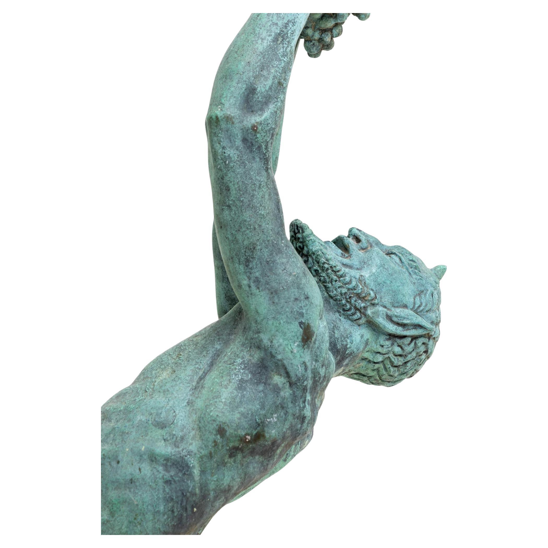 Large patinated copper sculpture of a naked dancing satyr in dynamic posture balancing on a small landscape base. He holds a vine over his face with both outstretched fists and bends his upper body far back. Signed May Mond 1928 on the base.