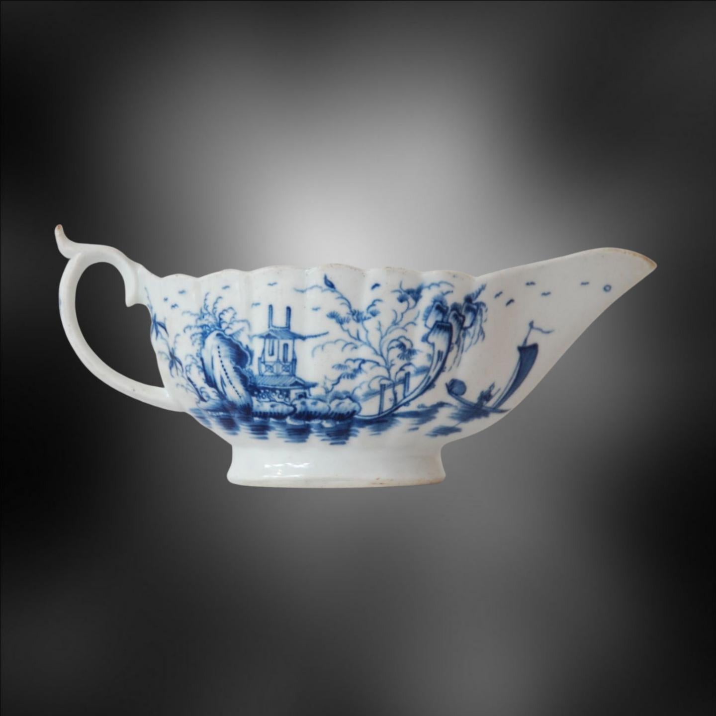 A fluted sauce boat, decorated with the rare Mission Church pattern in cobalt under-glaze painting.

This rare pattern is found only on sauce boats. This example is unusually large and finely painted, and is distinctly superior to other examples