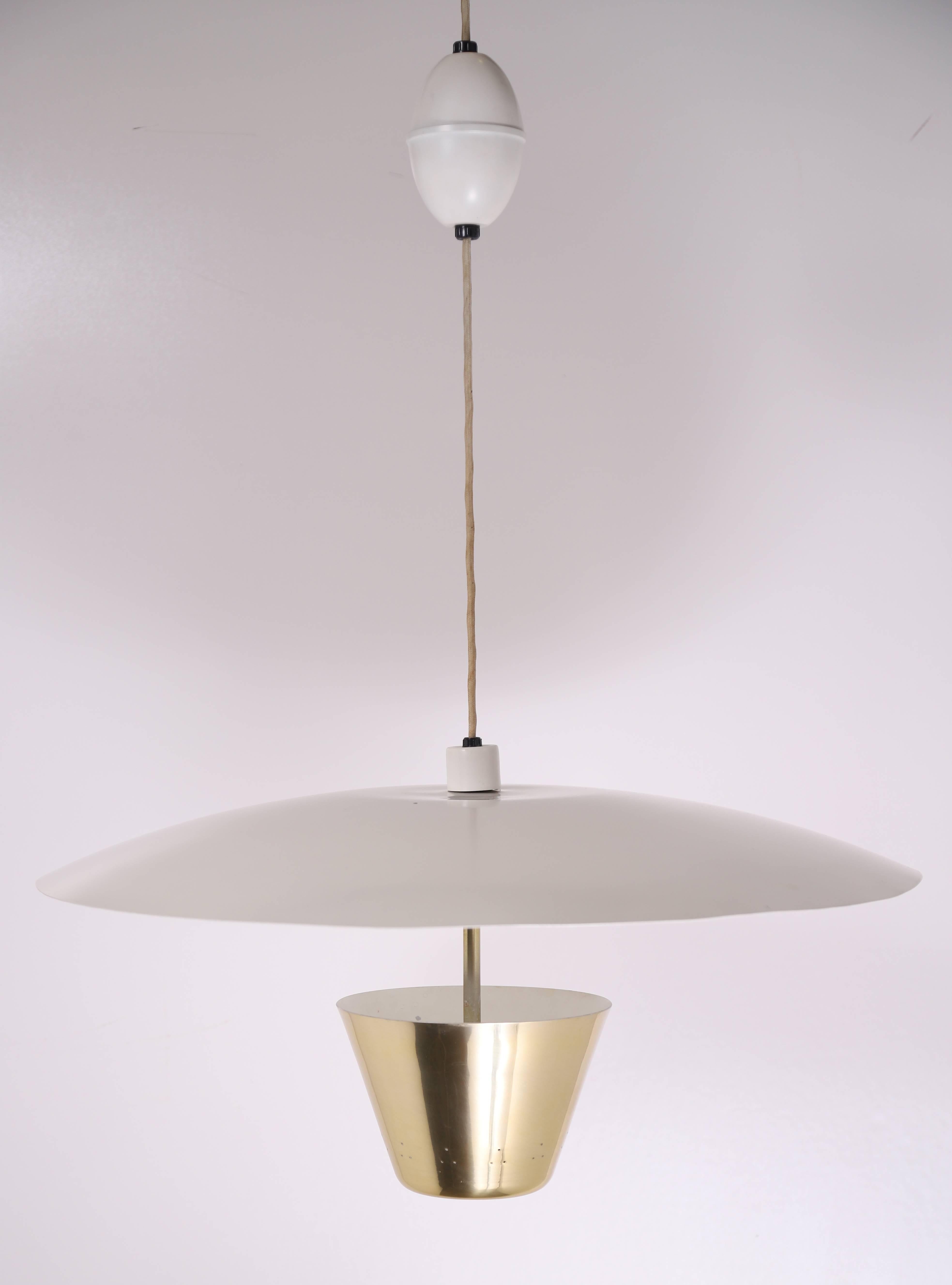 Stunning pendant light with enameled saucer and brass cone. Designed by Edward Wormley for Lightolier. Features original height adjustment 