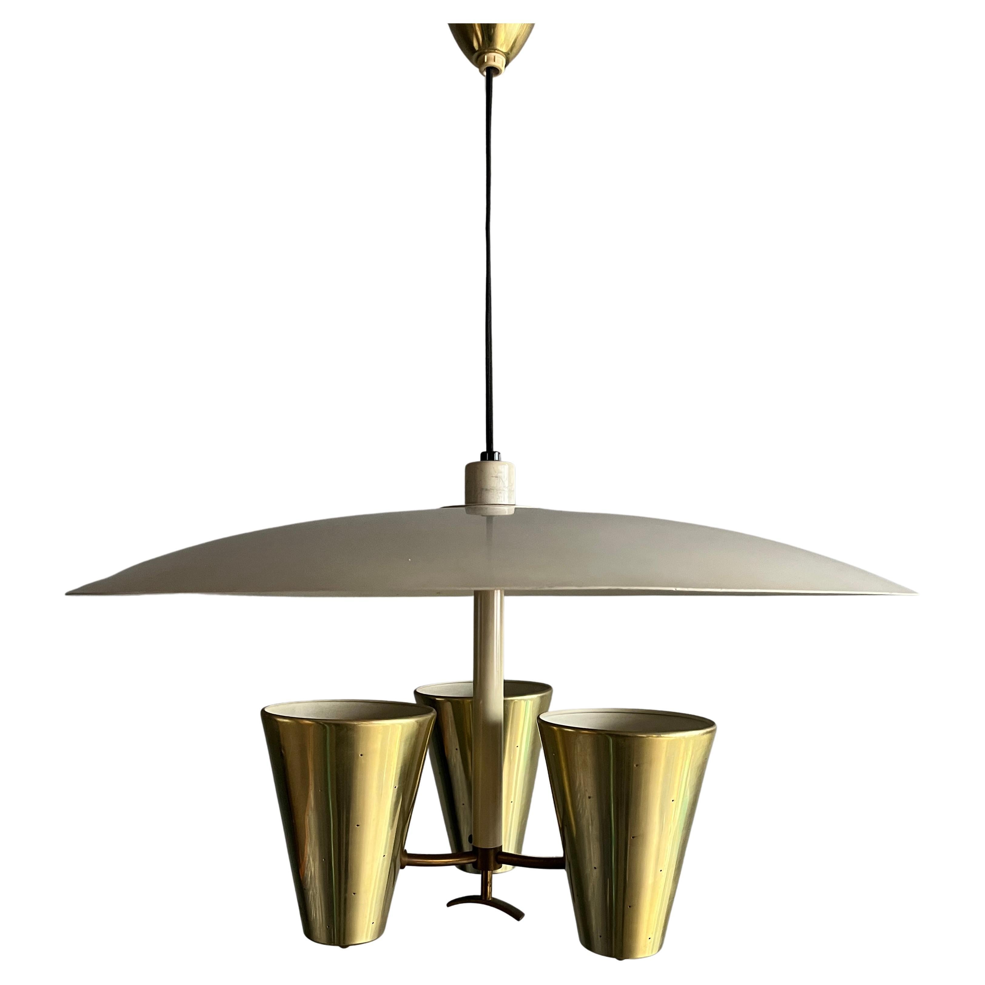 Stunning Midcentury pendant light with enameled saucer and brass perforated cones. Designed by Edward Wormley for Lightolier. Features original height adjustment 