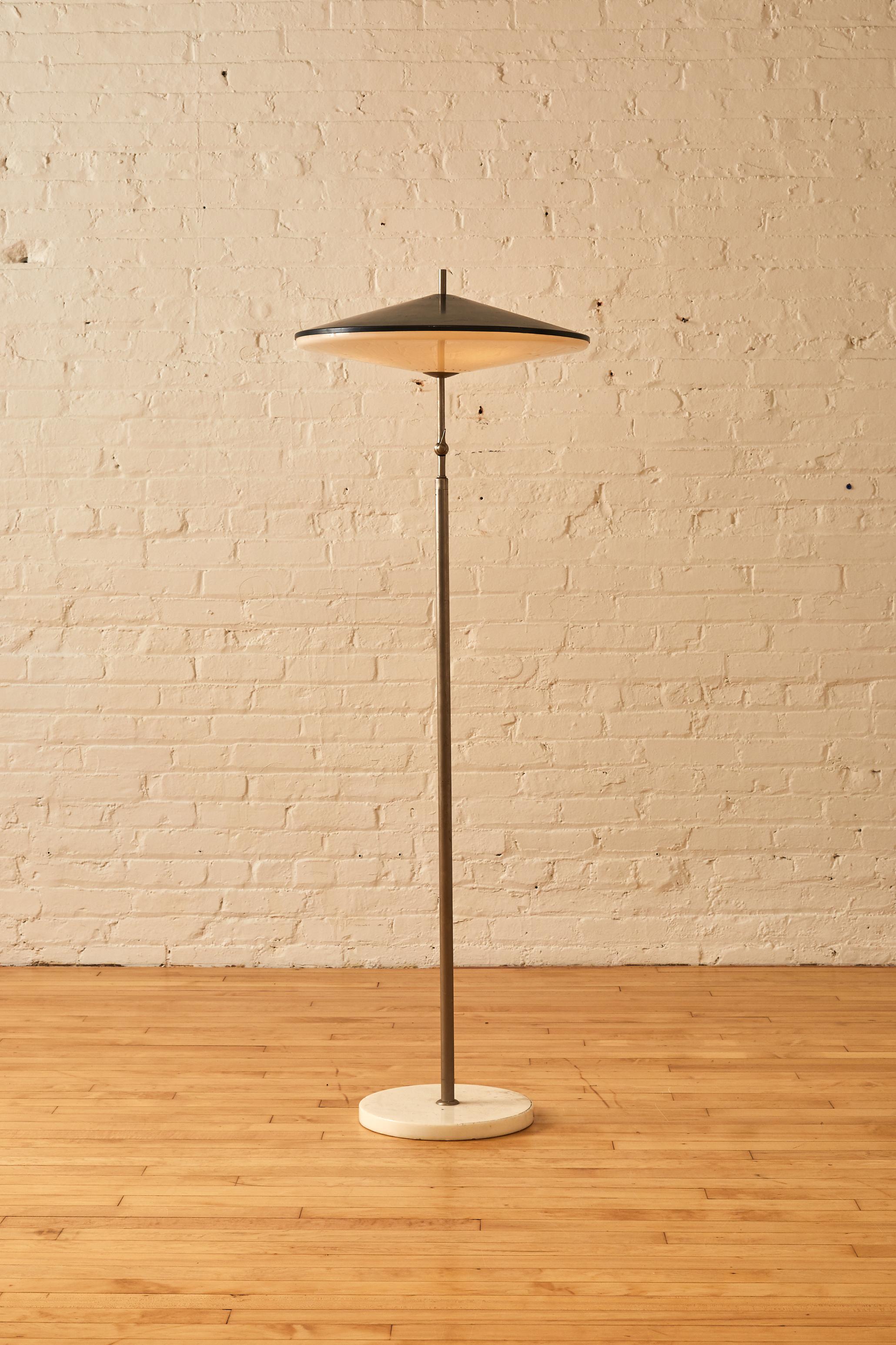 Saucer shade floor lamp in the manner of Giussepi Ostuni on a marble base, featuring plastic and metal shade.