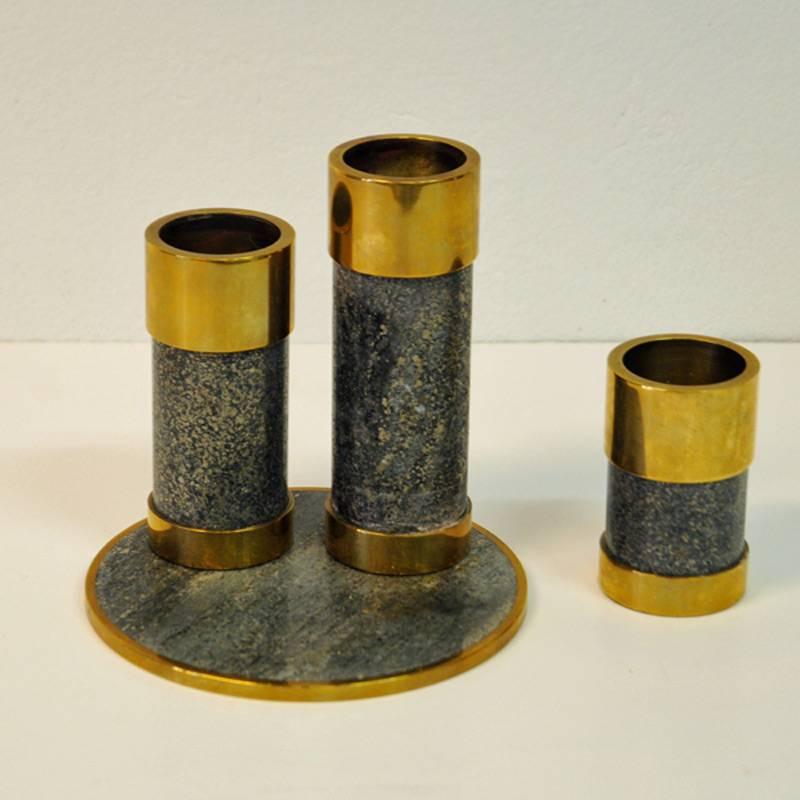 Candleholder set of three gathered on a stoneplate, made by Saulo AS in Sulitjelma, Norway. A Norwegian product from the 1970s with beautiful polished stone and brass edges on top and bottom. To be used for tea lights. There is blue felt on the