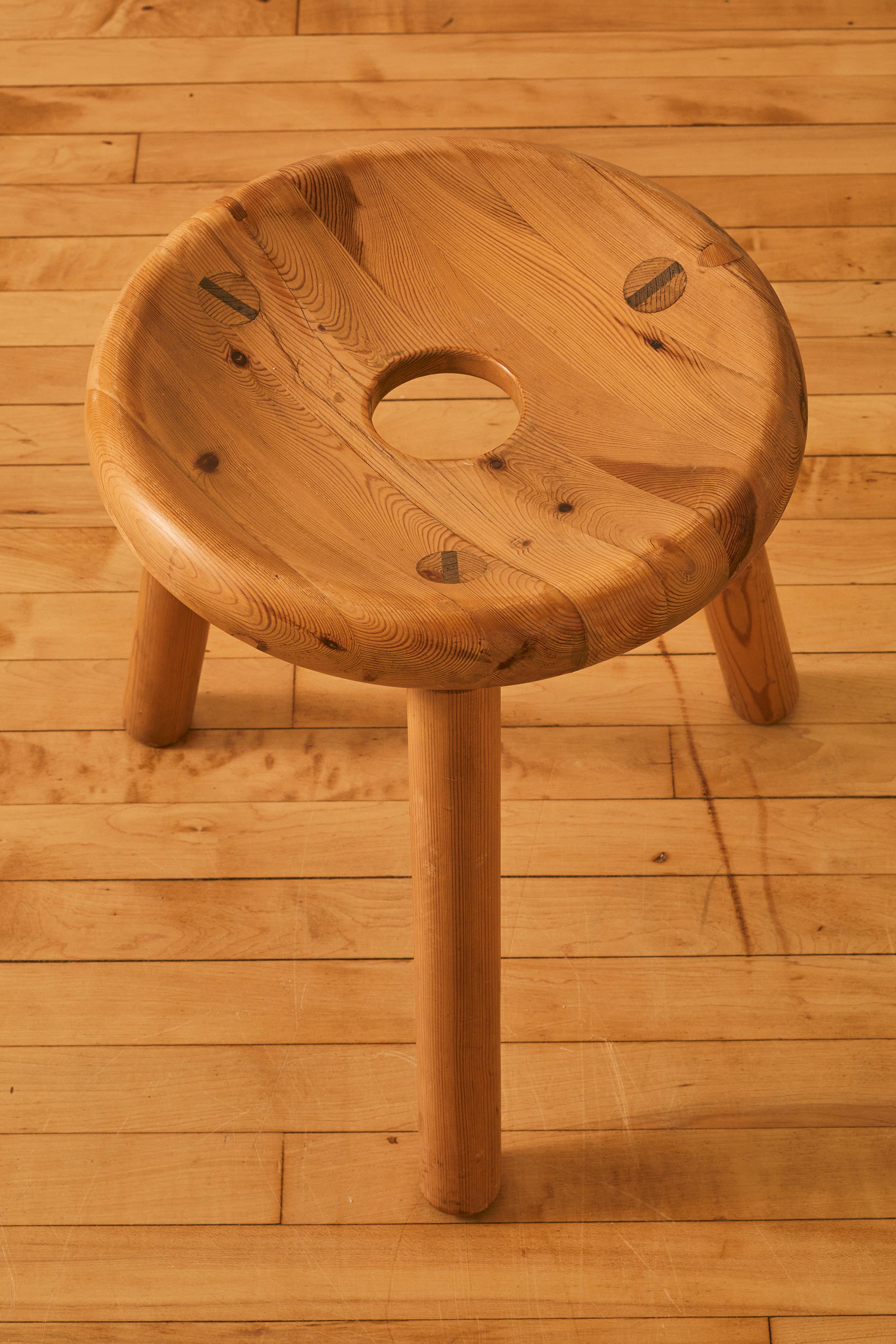 wooden stool with hole in middle