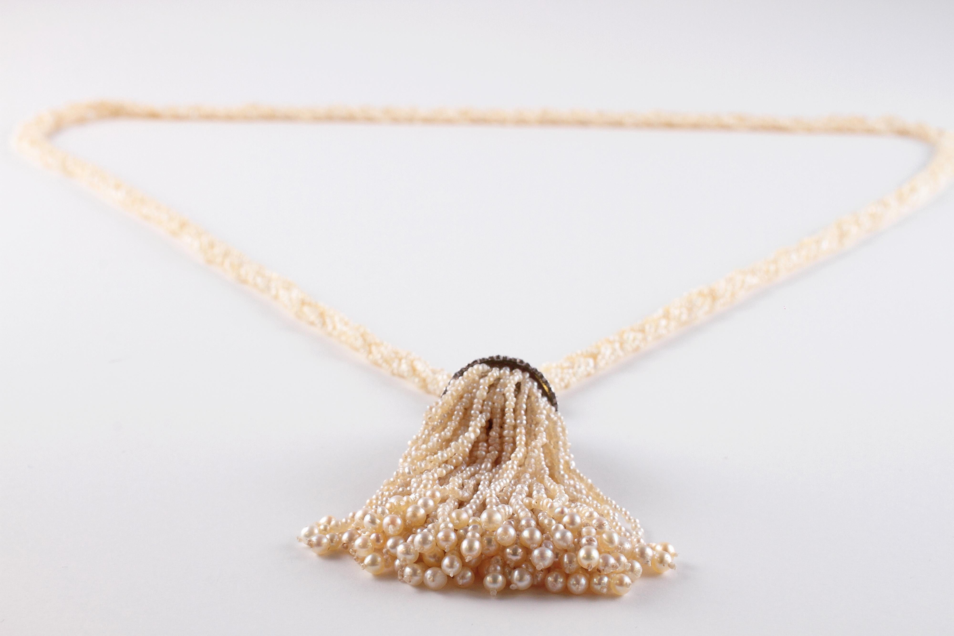 A treasure from days past!  This lovely sautoir necklace is circa 1900.  The upper braided pearl portion ends in platinum and diamond end caps and a platinum and diamond cap supports the tassel below.  The diamonds are a mixed group of older cuts