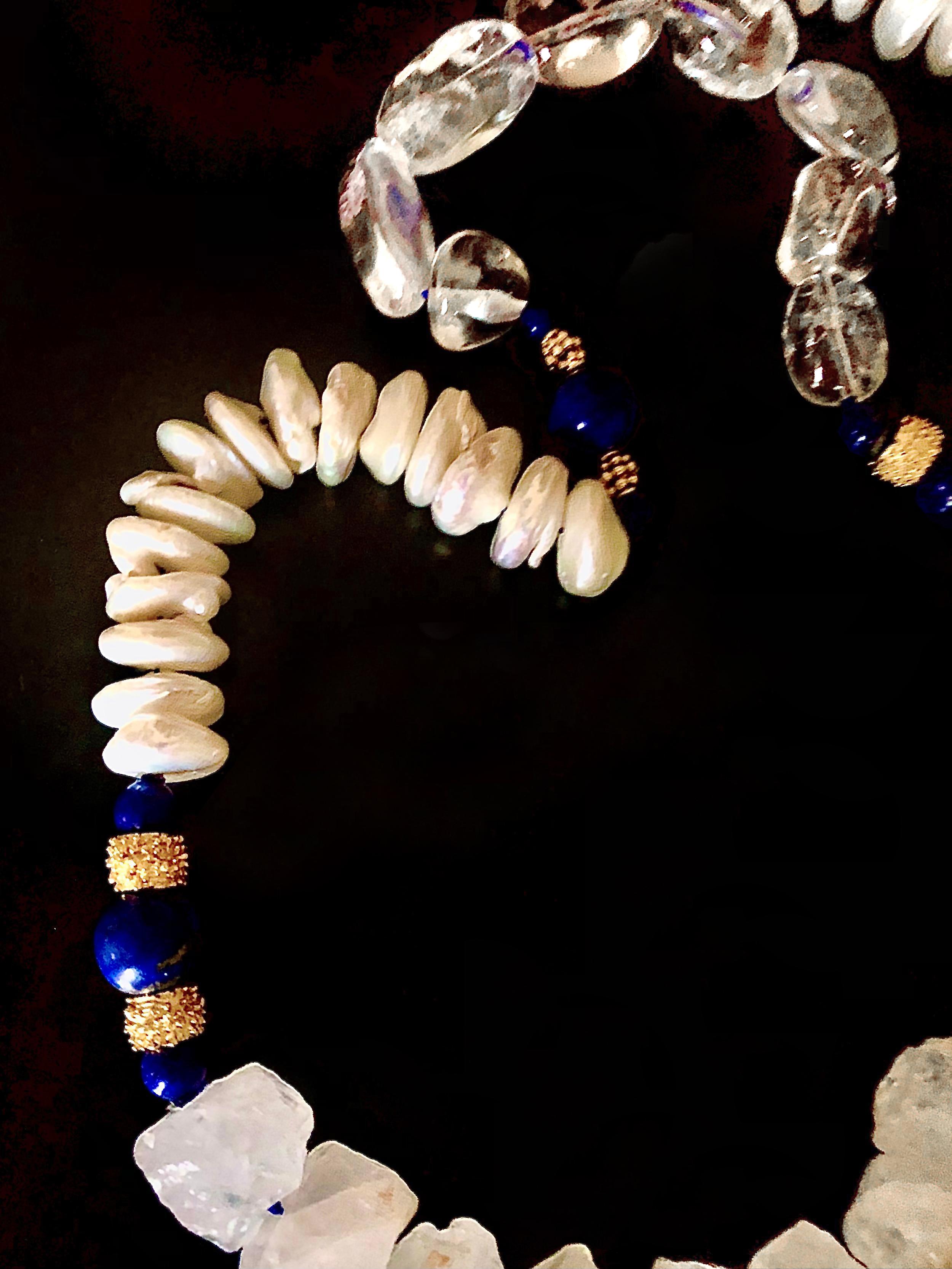 Sautoir with elegant, interesting mélange of freshwater lustrous cultured coin pearls, lapis lazuli beads and large tumbled rock crystal nuggets both smooth and crystalline. The piece is accented with richly gilded brass granulated rondelles. All