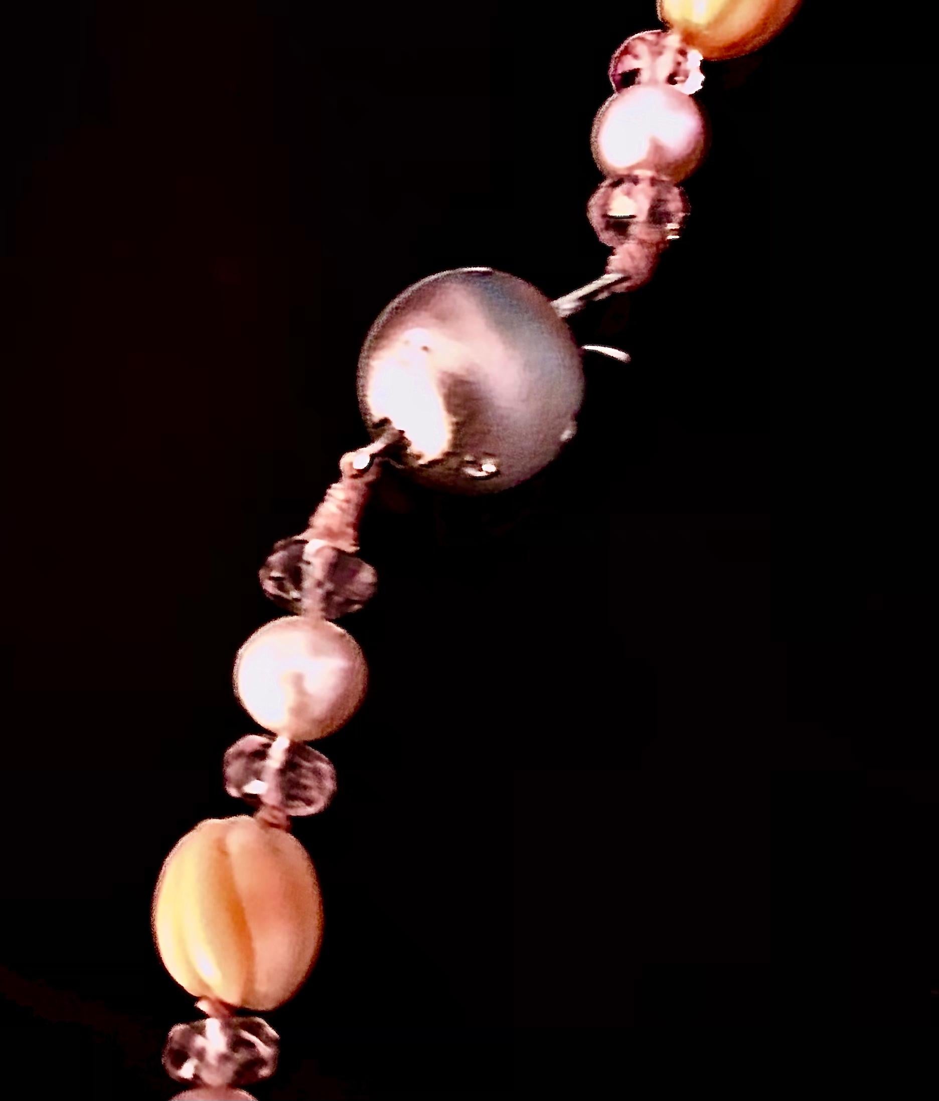 Sautoir with a wonderful pairing of graduated carved rare peachy pink torchon carved coral flanked by pink faceted morganite rondelles. Each rondelle flanking a cultured freshwater round pink pearl. Finished with a 14kt satin white gold ball clasp