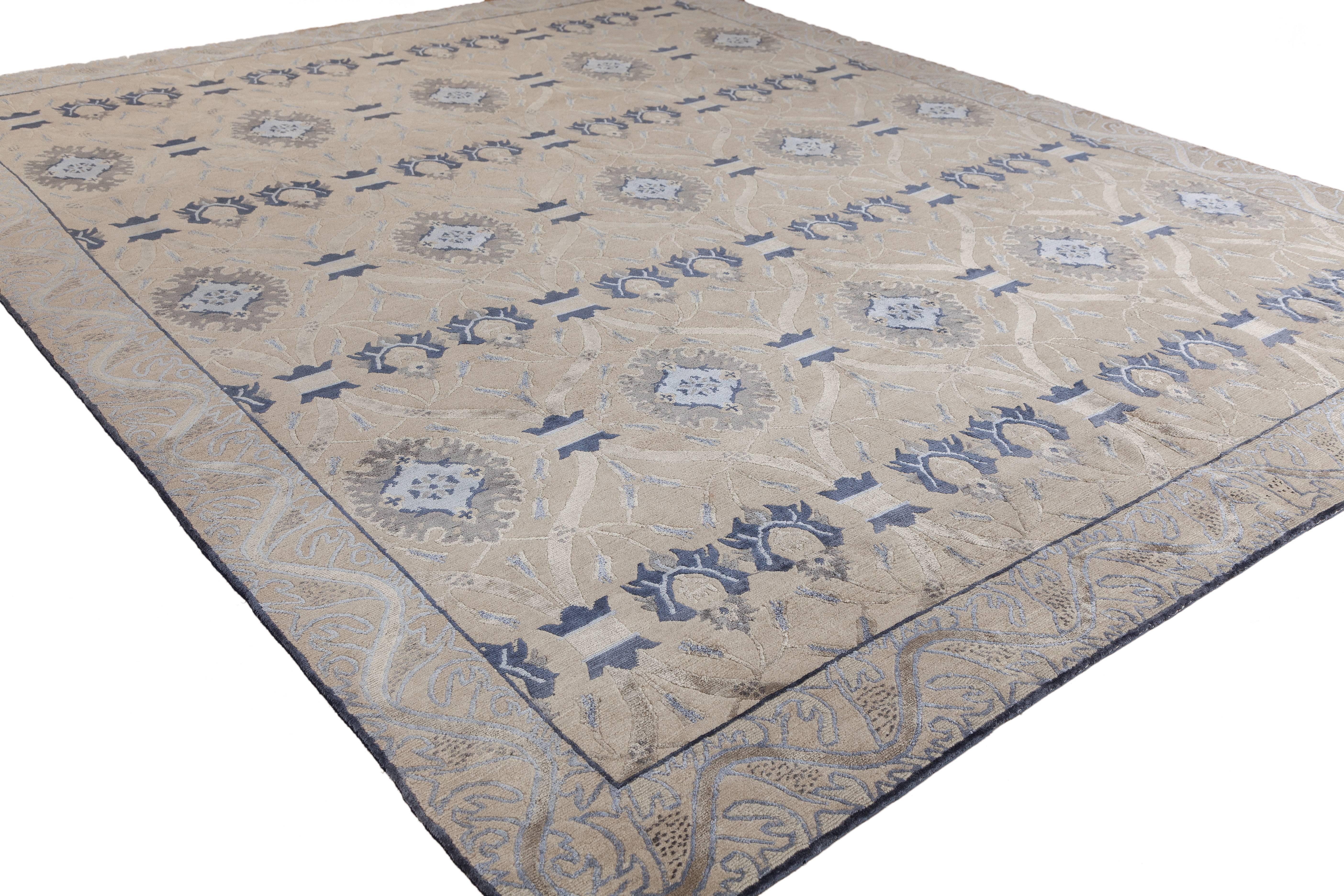 A perfect blend of Classic and modern sensibilities. A revitalization of a Classic brocaded pattern with an elegant vine border. This coloration features a shark-grey Tibetan wool background with design motifs in silver, periwinkle-blue, rich navy