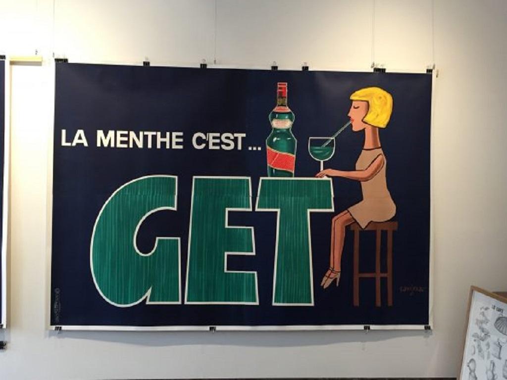 Rare oversize get by famous french artist Savignac. Jean & Pierre Get created this Creme de Menthe in 1796. Get (pronounced Jet) became known as Get27 because of the high alcohol content. 200 years later, with slightly lower proof, Get27 continues