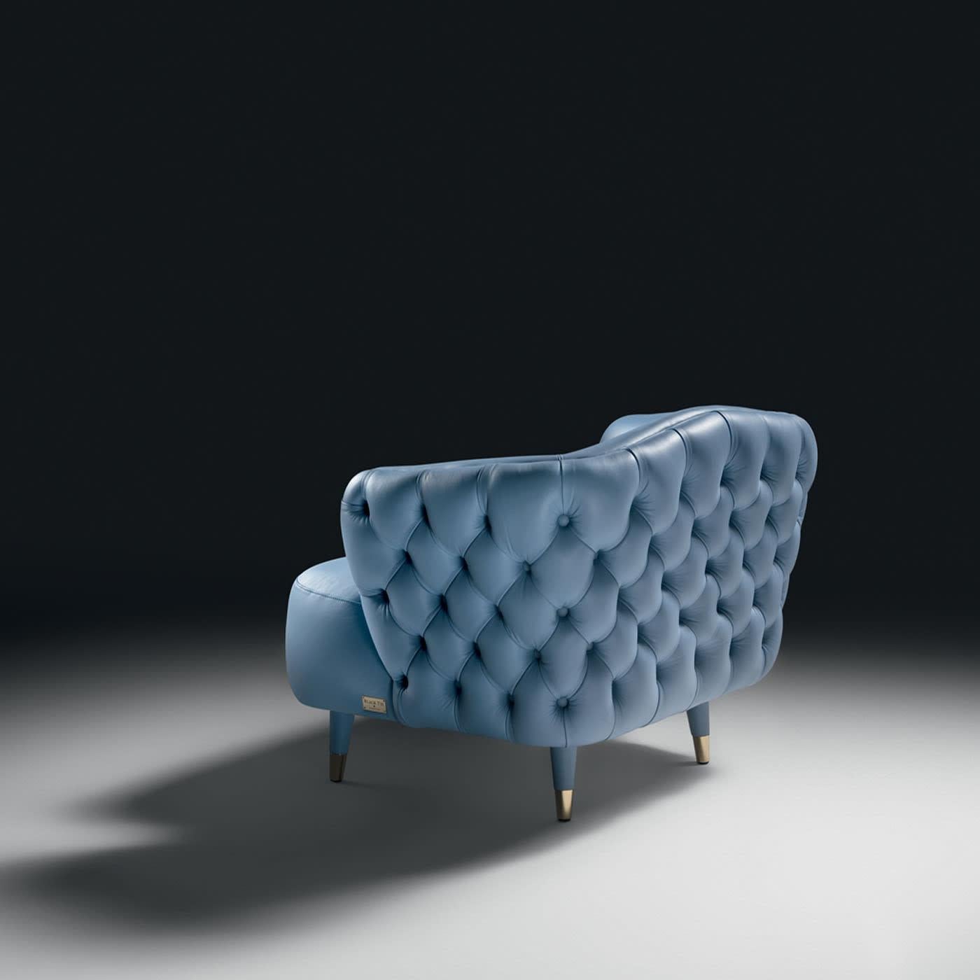 An authentic furnishing gem with a solid wooden core padded with high-density different-quote polyurethane foam, this lounge chair boasts a precious sartorial look emphasized by fine leather upholstery in a dreamy azure hue. Tapered feet with glossy
