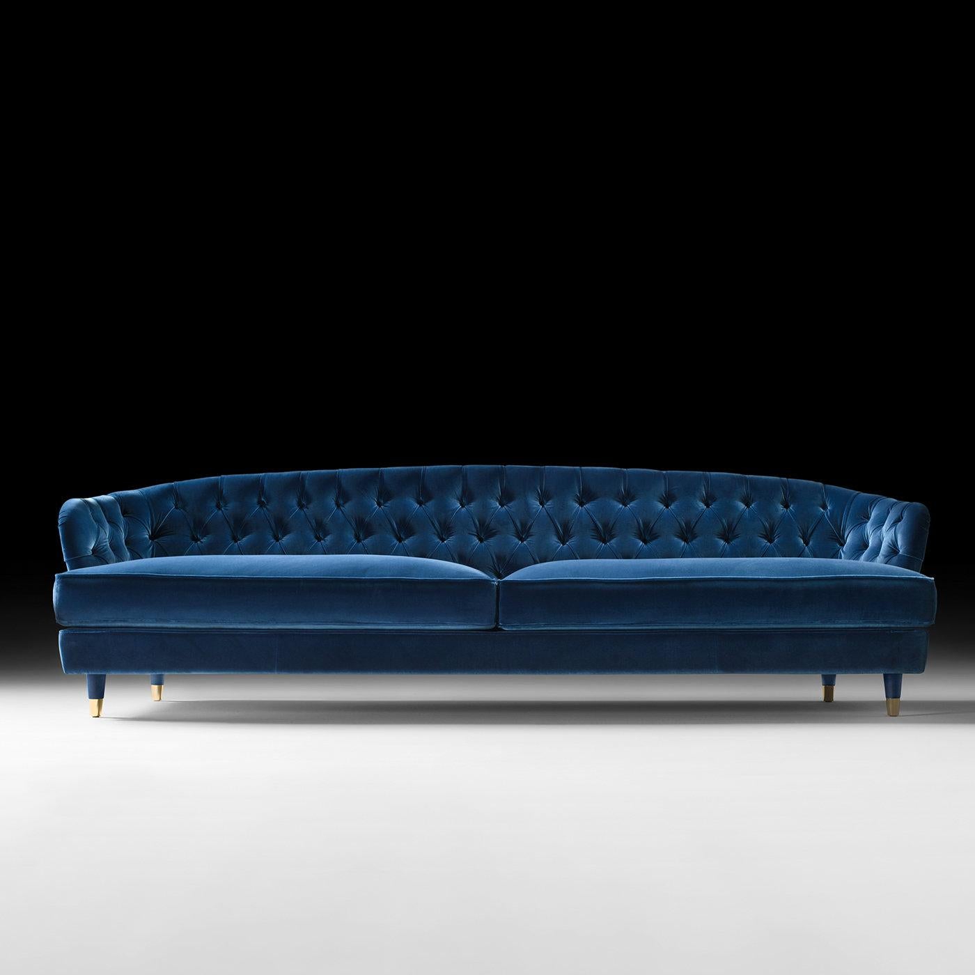 This superb sofa boasts a gleaming and strong personality in its intense blue color and soft velvet upholstery. The structure is made of solid wood and boasts an elastic belt spring system. The padding is divided in two separate levels for a higher