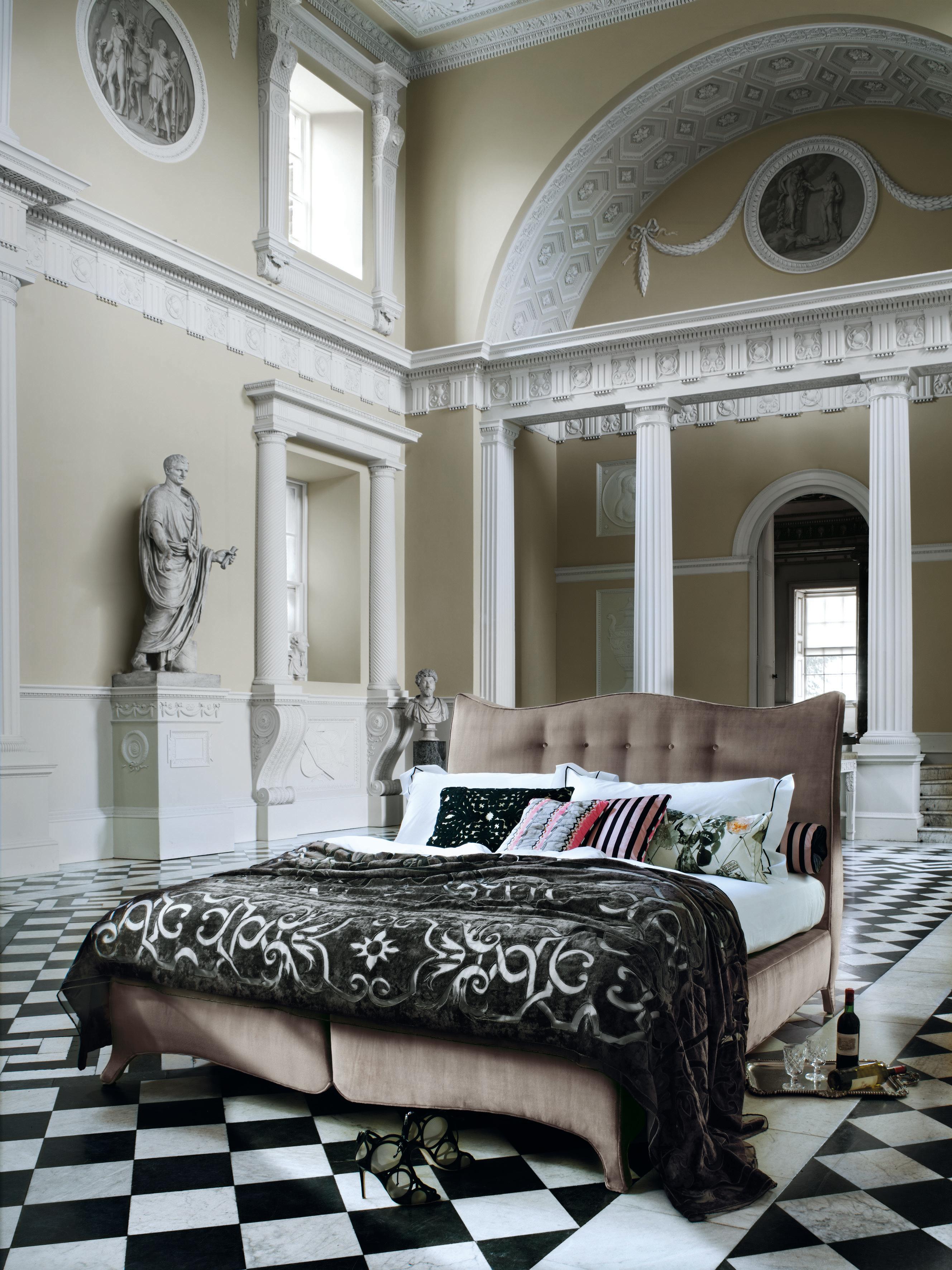 A Savoir classic design. Reminiscent of the sculptural and feminine lines of the baroque period, the exaggerated curves of the Penelope headboard and base evoke a feeling of grandeur. Legs are seamlessly upholstered into the base continuing the