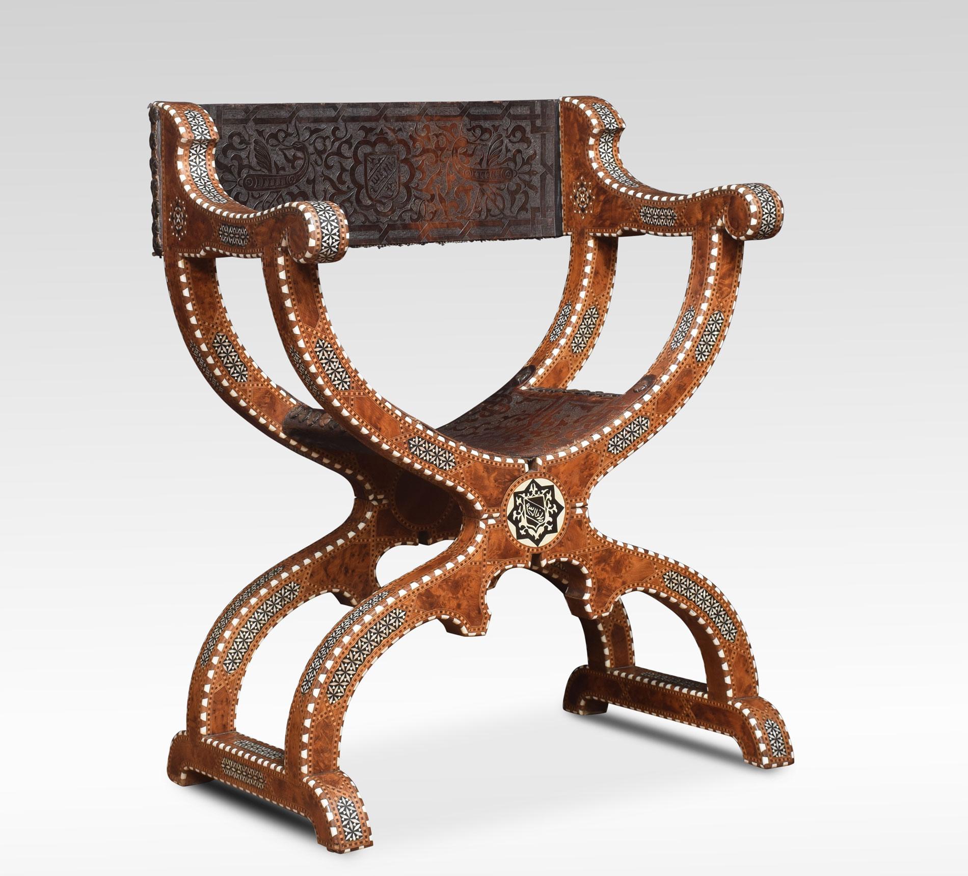Late 19th century Savonarola armchair. The leatherback over scroll supports and leather seat raised up on shaped legs and bracket feet. The chair decorated with pseudo calligraphy, shields, scrolls and geometric motifs.
Dimensions:
Height 35.5