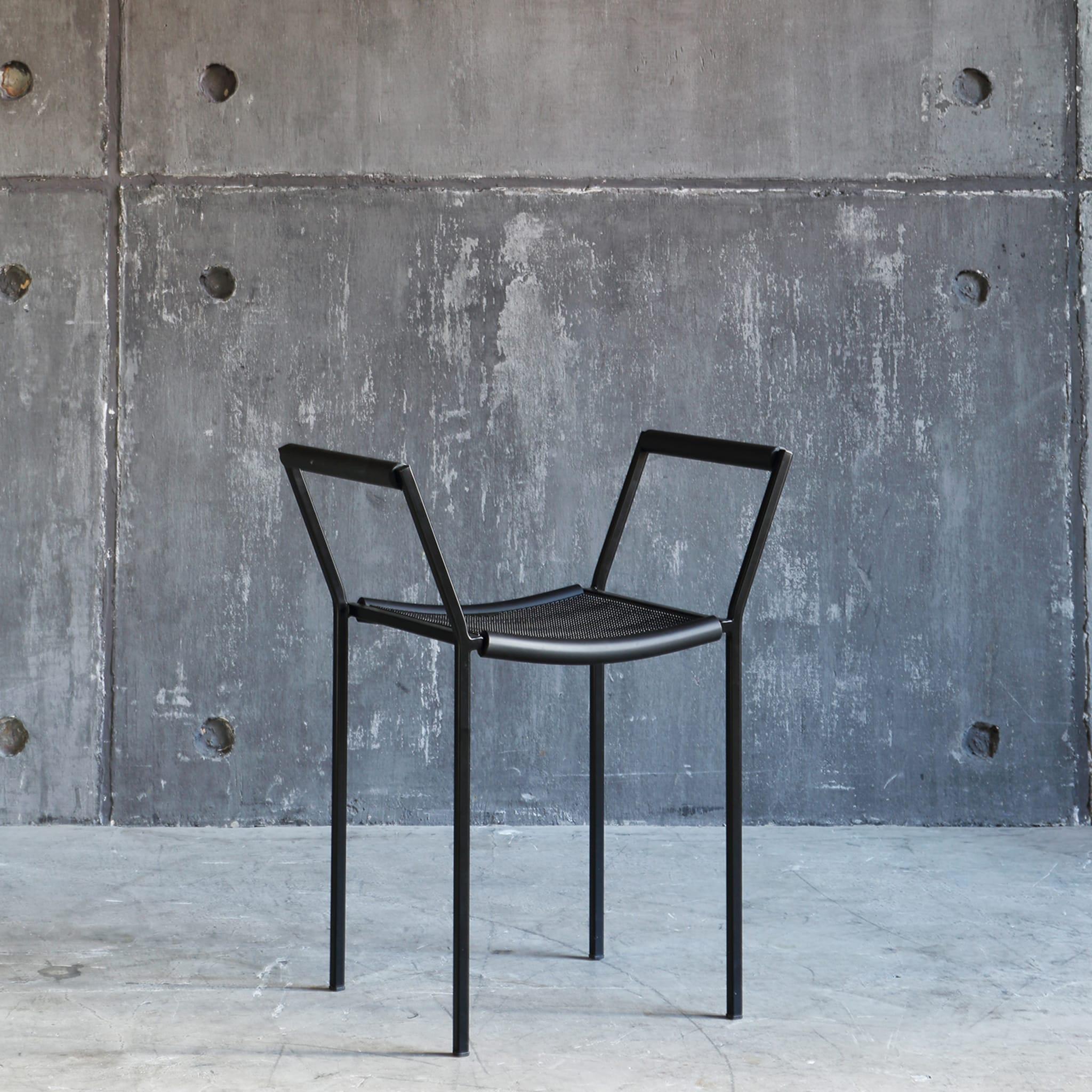 A modern take on Empire chairs, the Savanarola Chair comes in all new materials to give off a unique vibe. On a pure steel frame, the chair is coated with a semi-opaque black finish. The seat and armrests are then covered in textured black rubber,
