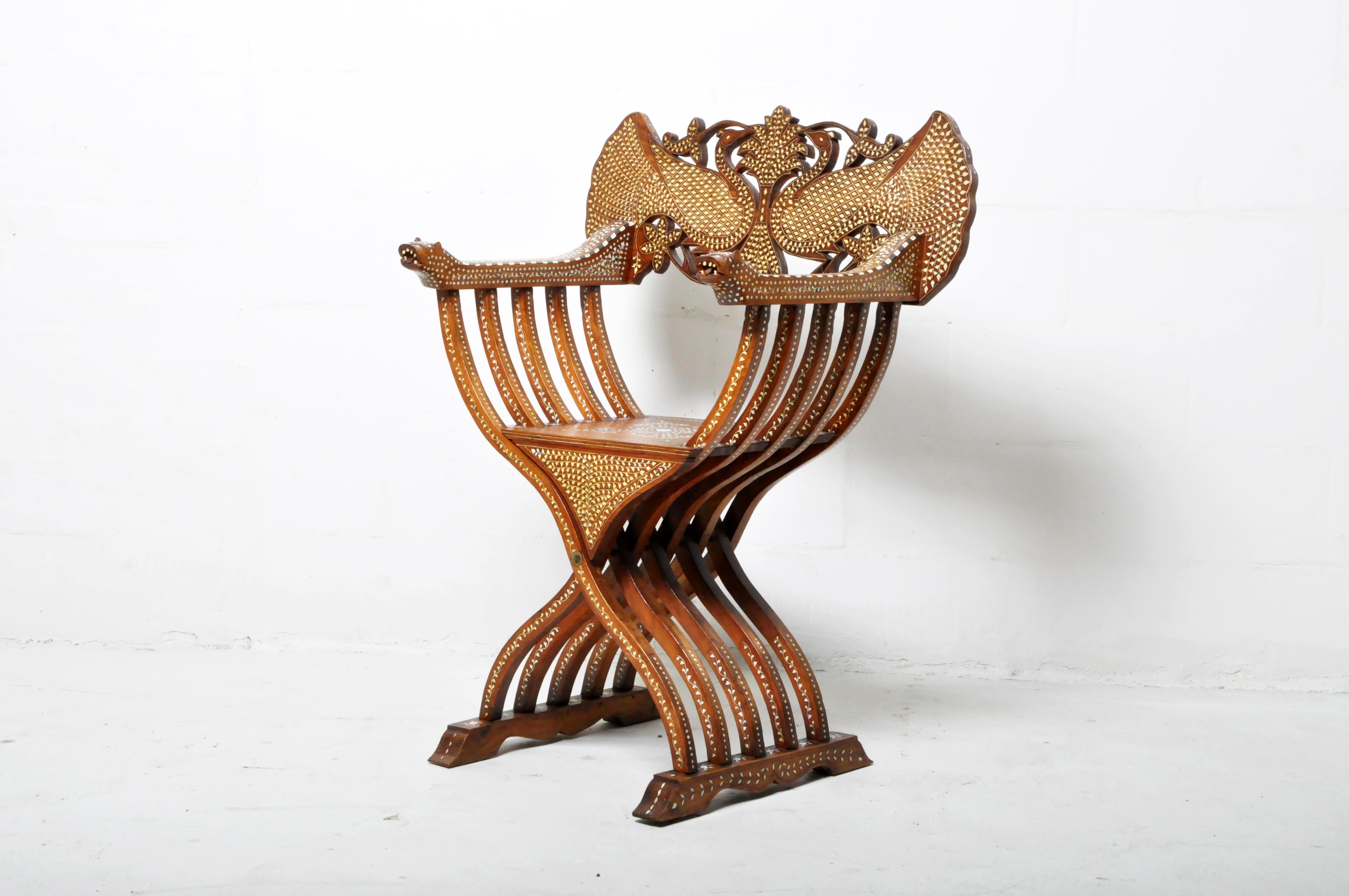 19th Century carved walnut folding scissors Savonarola chair with lion arms. Typical of the Italian Renaissance with carved a bone-inlaid back, the Savonarola chair is a type of folding chair with an X frame when viewed from the front or back. It