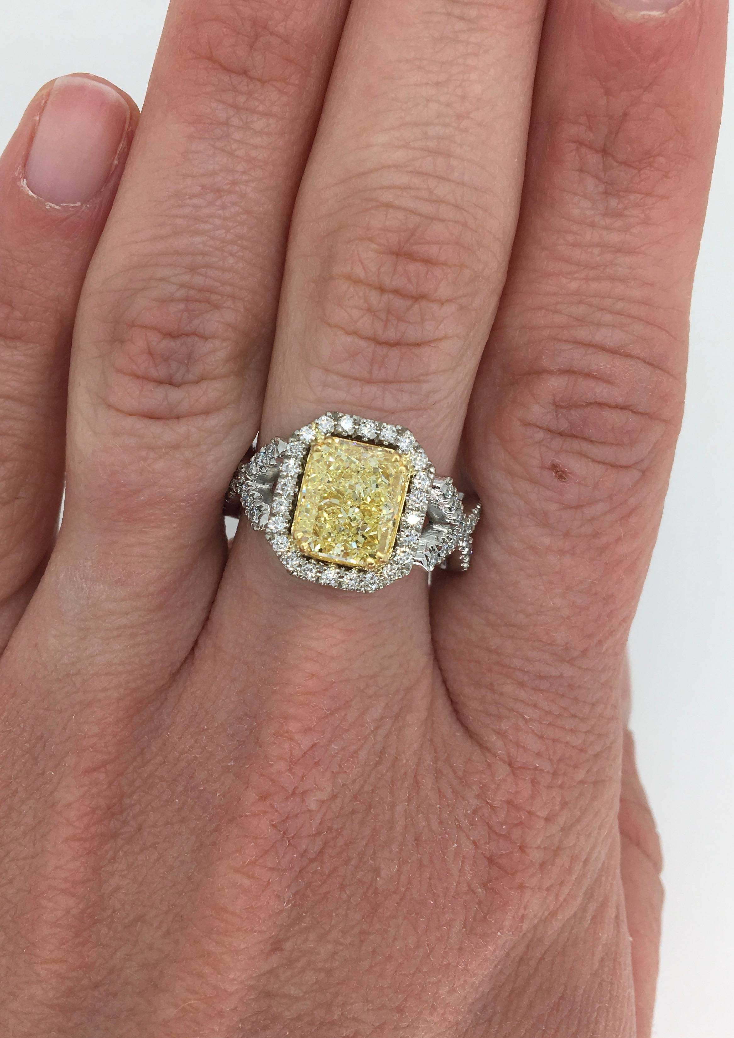 One-of-a-kind Savransky Yellow & White diamond ring. This ring features a gorgeous GIA Certified 3.38CT Cut Cornered Rectangular Cut Fancy Light Yellow Diamond in the center. The featured Diamond displays VS1 clarity.  The ring is adorned with 148
