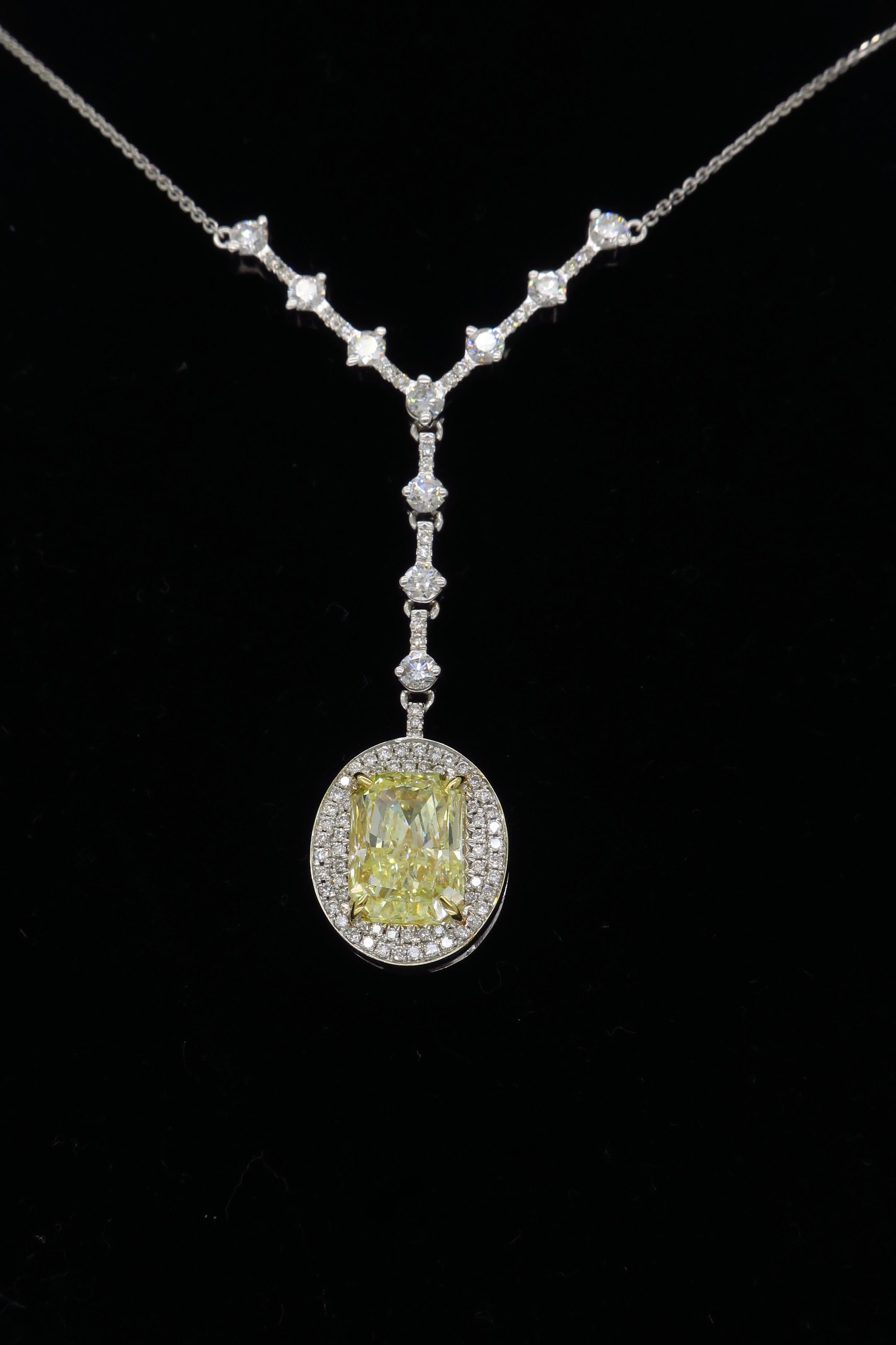 Elegant necklace that was hand crafted by designer Savransky. This necklace features a GIA Certified 4.00CT Radiant Cut Yellow Diamond, with VS2 clarity.   The featured diamond is surrounded by a double halo Round Brilliant cut diamonds, with an