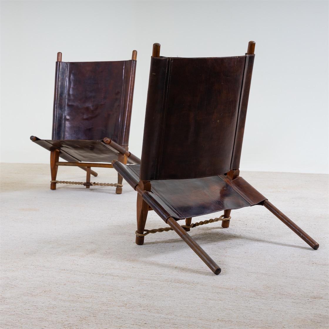 Set of four lounge armchairs with leather seats and backs, designed by Ole Gjerlov-Knudsen for Cado in 1958. One chair is slightly damaged.