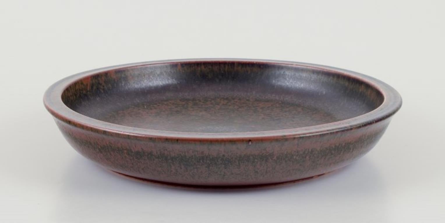 Saxbo, Denmark.
Ceramic bowl with brown glaze.
Approximately 1940s.
Ying Yang mark.
Perfect condition.
First factory quality.
Dimensions: D 24.0 cm x H 4.0 cm.