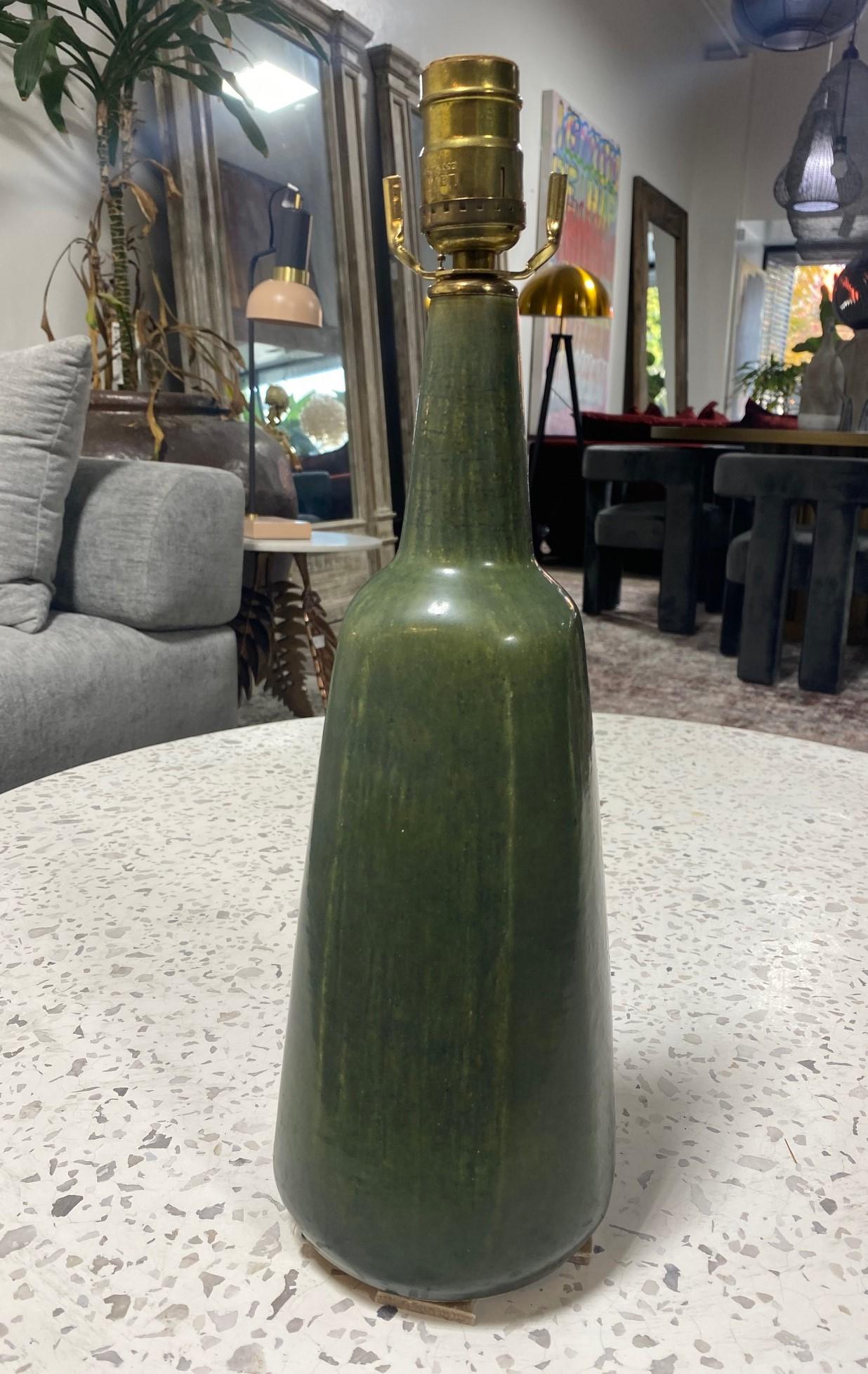 A gorgeous and somewhat rare Scandanavian stoneware pottery table lamp featuring a green hare's fur glaze by famed Danish designer/ceramist Eva Stæhr Nielsen for Saxbo. This piece is marked 
