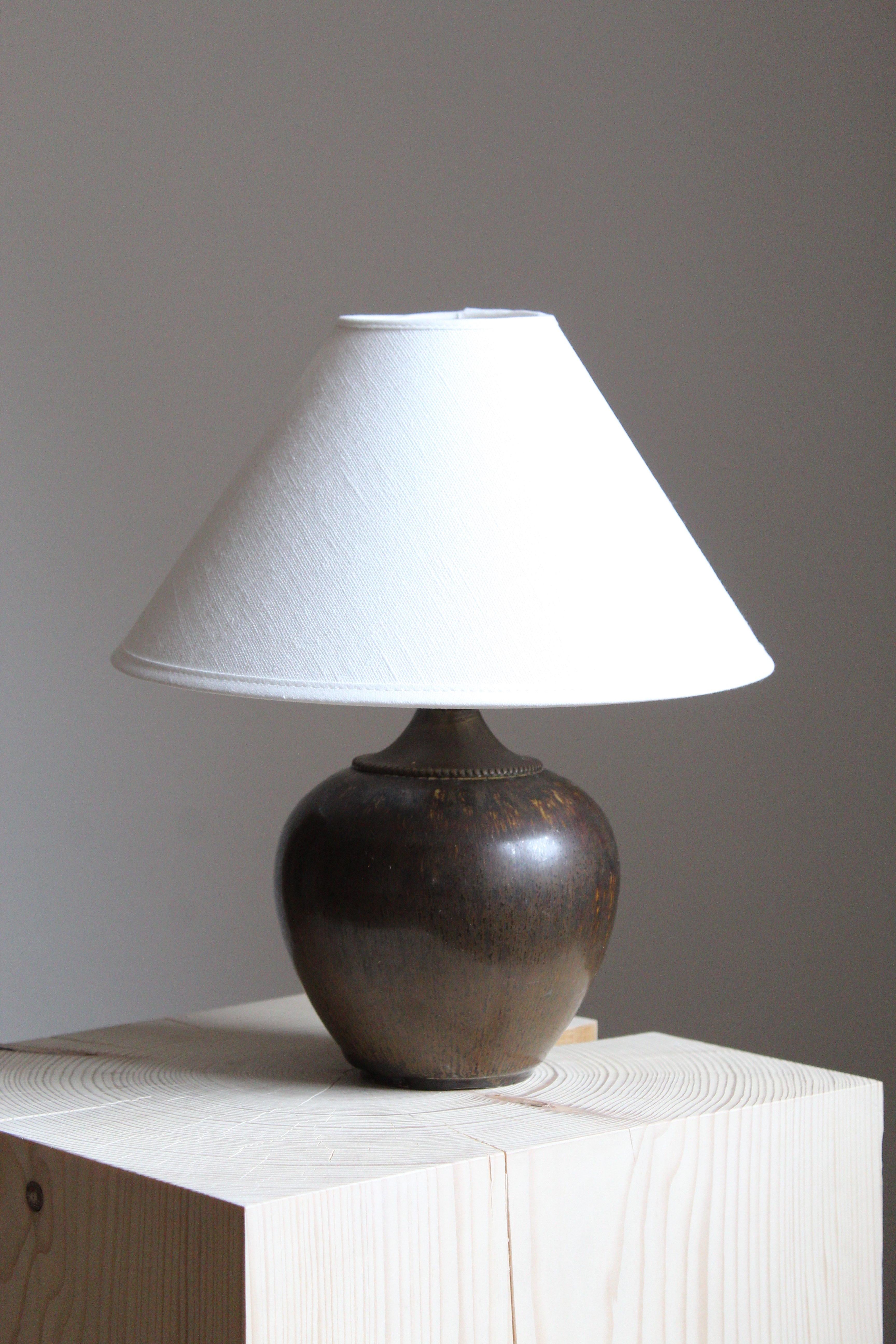 A table lamp, produced by Saxbo, Denmark, 1950s. Possibly designed by Eva Stæhr-Nielsen. Sold without lampshade.

Other designers of the period include Gunnar Nylund, Axel Salto, Carl-Harry Stålhane, Wilhelm Kåge, and Arne Bang.