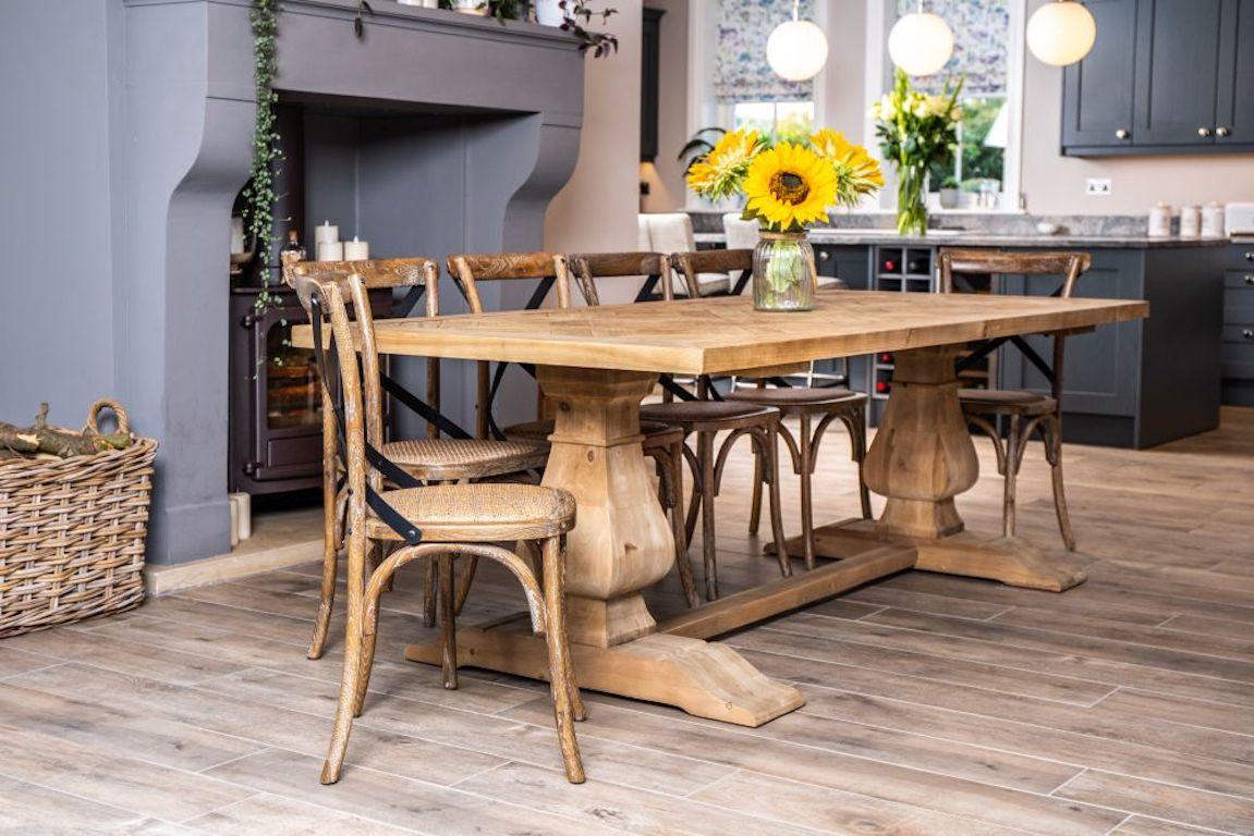 A fine Saxton reclaimed pine dining table, 20th century. 

This French provincial inspired dining table will make all of your classic French decor dreams come true. The perfect dining table for a large rustic farmhouse style space, the table can