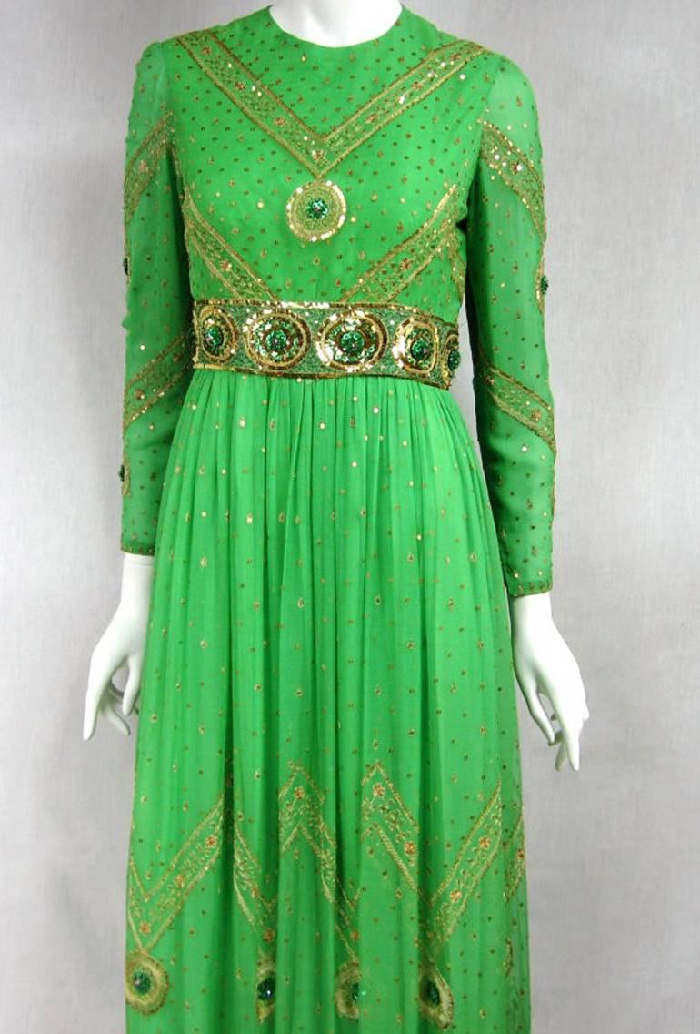 1970's Silk Dream Gown and this color is amazing. Flowing Layers of silk. Has a Hidden Zipper down the back, 3 hook, and eye closures. Snaps on the wrist Loads of sparkle scattered throughout this amazing gown paillette sequins, Saz by Surjit and