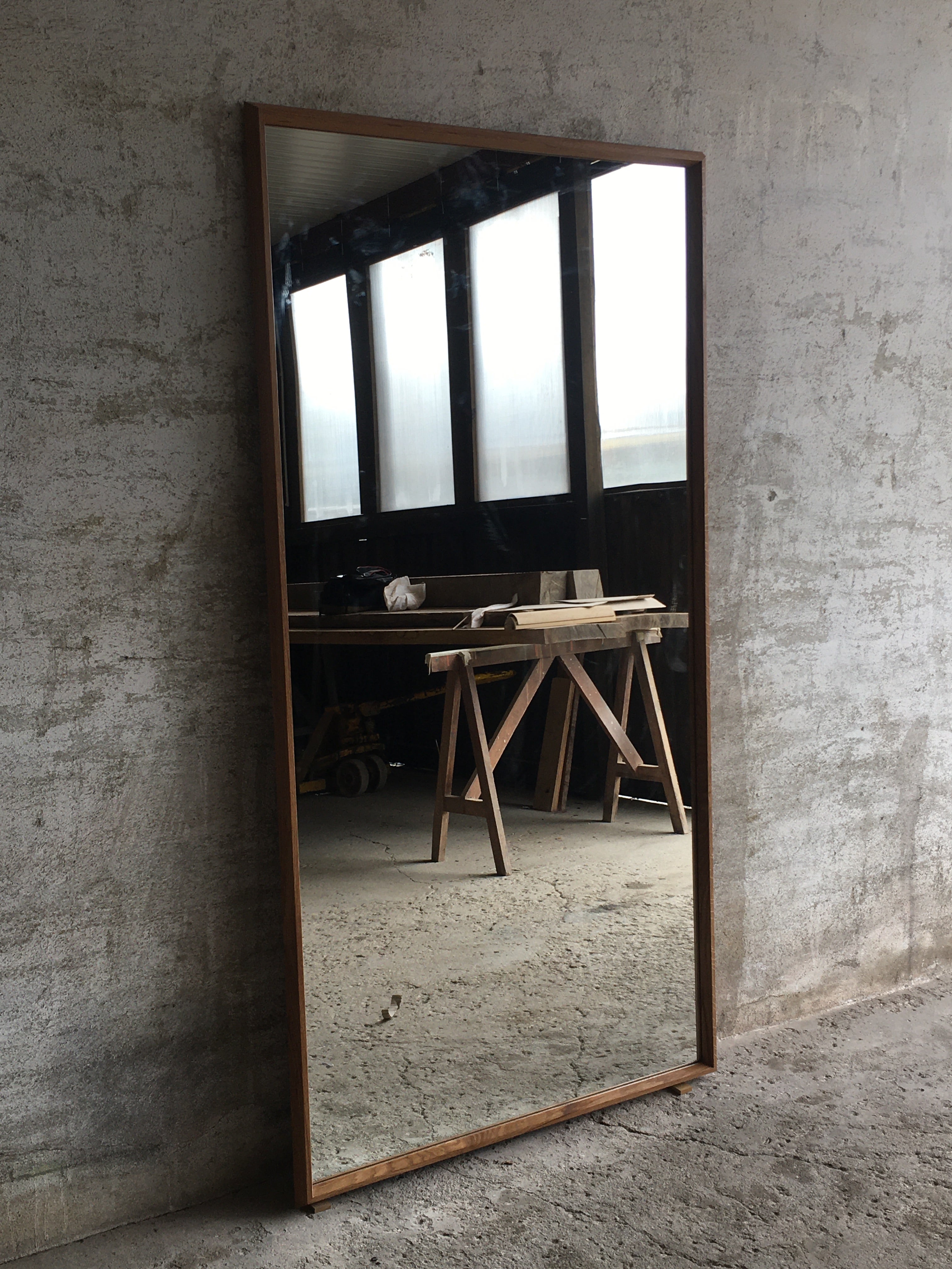 This carefully designed and handcrafted wooden mirror frame, designed and made by Tomaz Viana consists of a very angular profile made from a very expressive grained Iberian oak with several knots. It frames a 4mm mirror and a 6mm plywood board gives