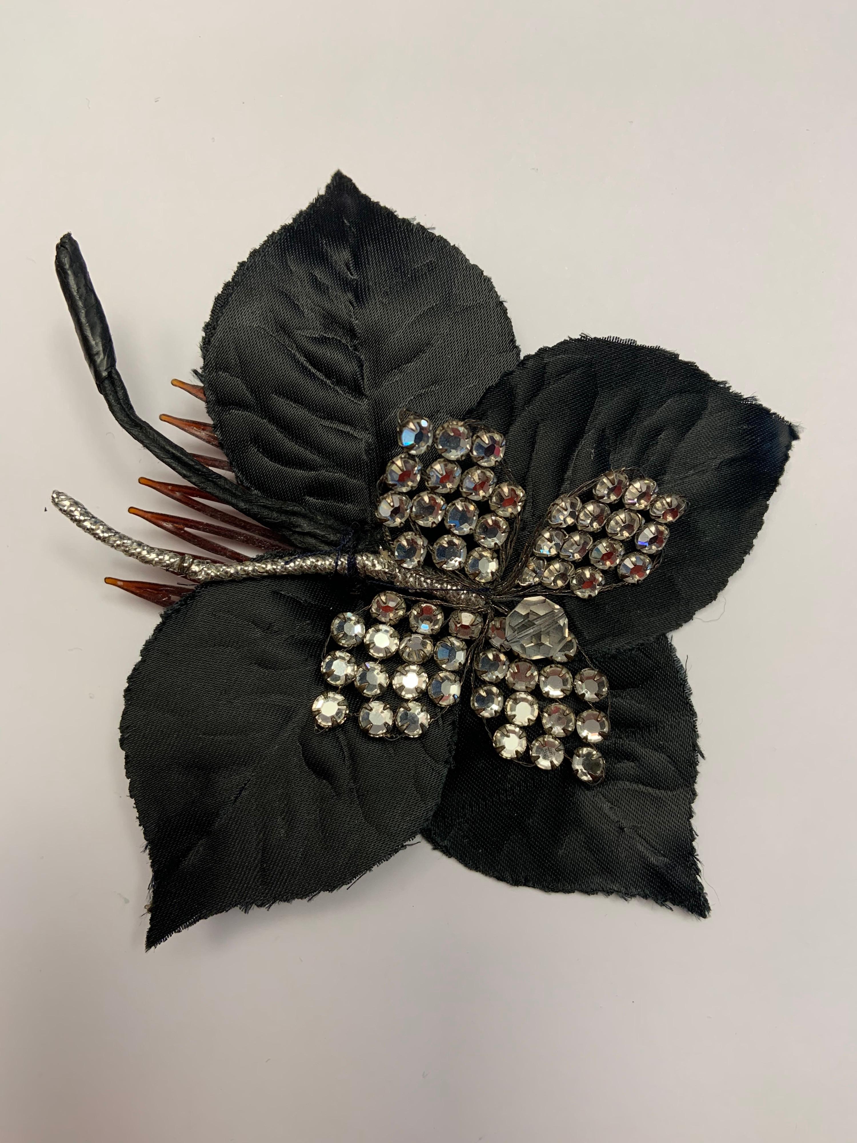 Arnold Scaasi, best known for designing stylish clothing, created this chic hair ornament with four large black silk leaves topped by four prong set rhinestone leaves with a faceted crystal bead in the center. This is hand sewn to a small hair comb.