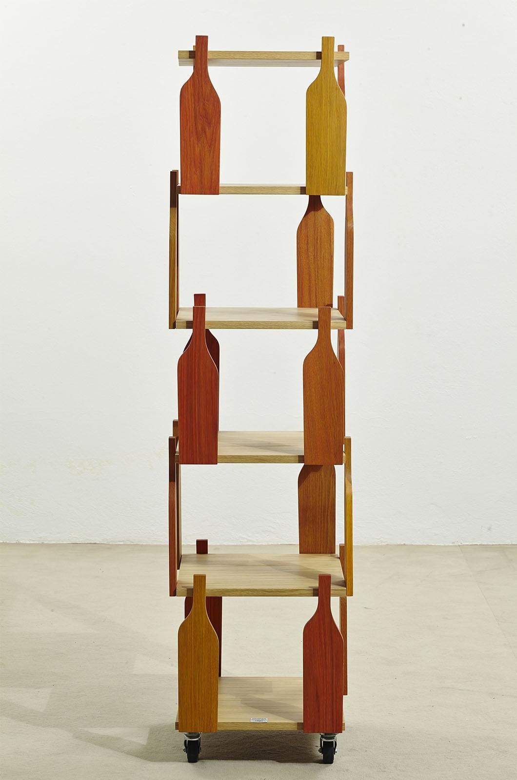 Wooden storage cabinet with casters, designed by H.J. Weinand for Memphis Milan in 1992... Intermediate shelves are connected by wooden bottle silhouettes in different warm colors. The entire container is made of wood 