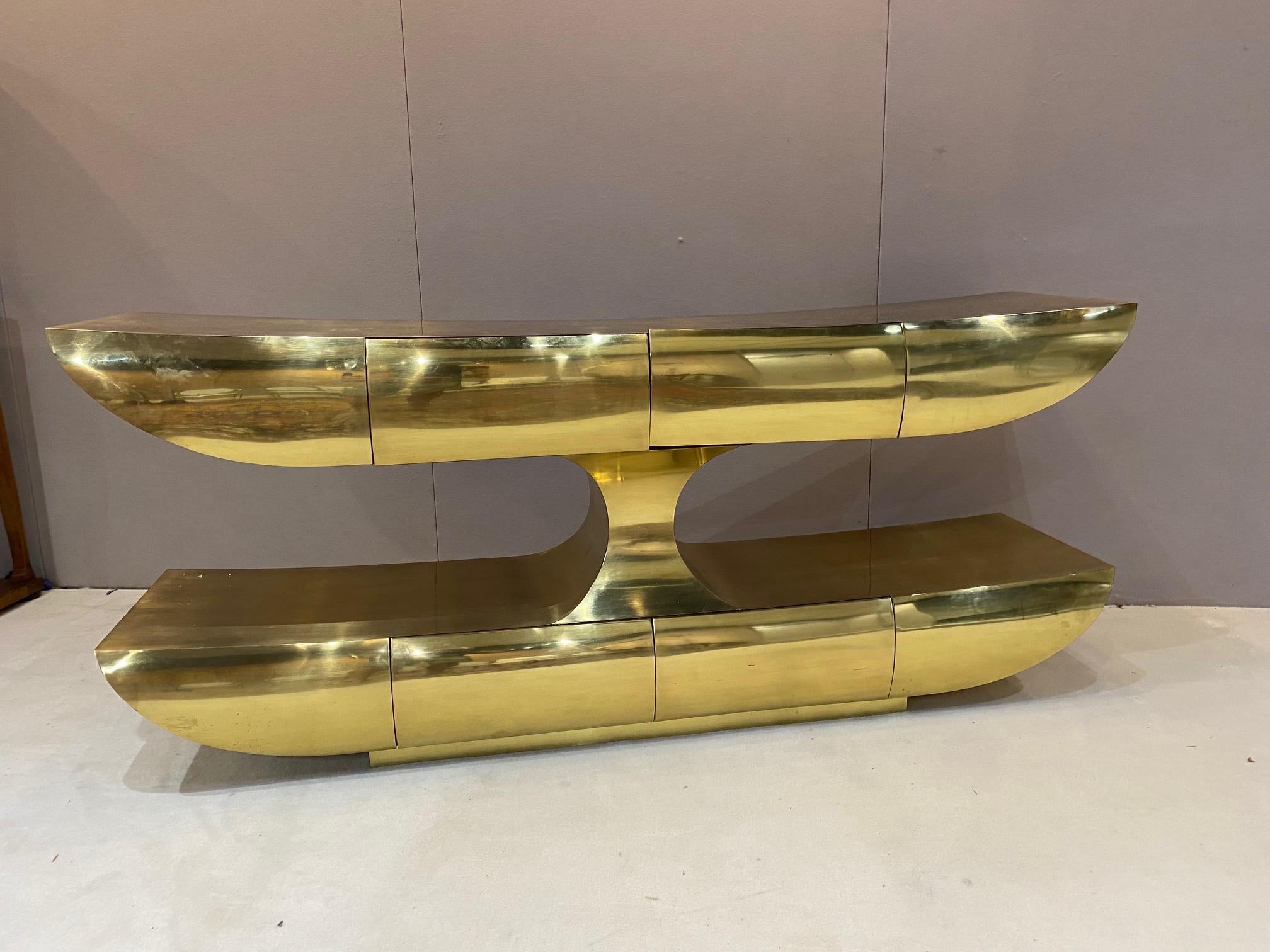 Rare brass console. Brass clad with highest quality Italian craftsmanship. Mahogany elements. Drawers are finished all around in typical Italian high style manufacturing. Measures: 78 1/2 inches long by 33 3/4 inches tall by 20 1/2 inches wide.