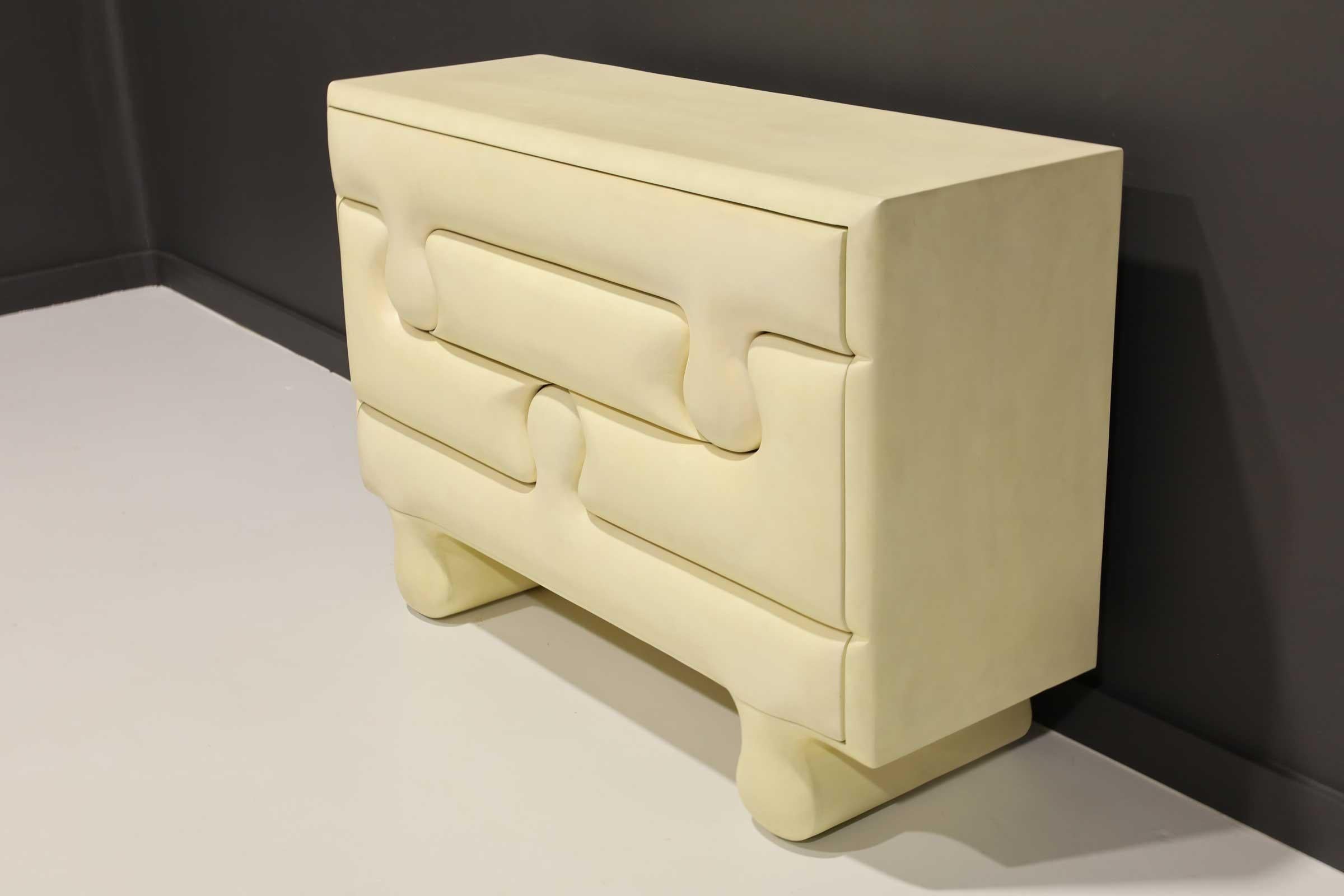 Scala Luxury goatskin puzzle chest. This puzzle chest is manteled with goatskin and has a low sheen hand polished lacquer finish. Inside the cabinet is finished with a high-gloss polished white lacquer. The drawers open/close on push (touch latch