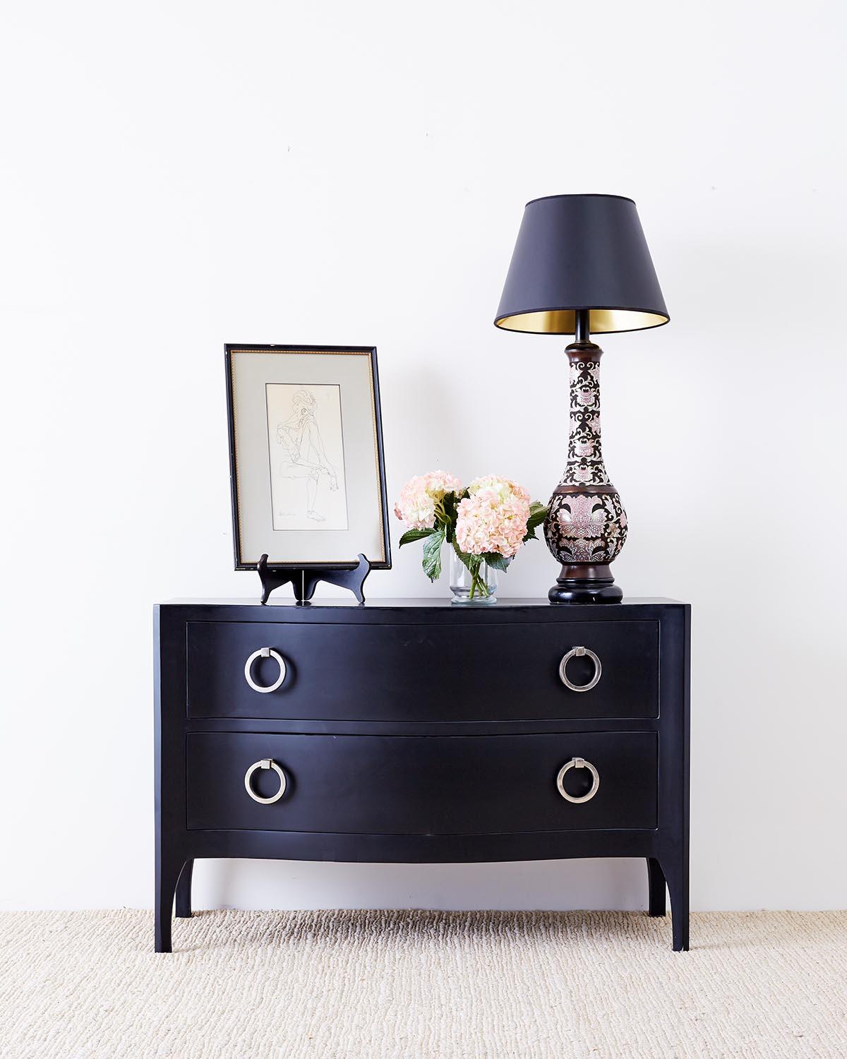 Stunning bow front chest of drawers or Trapu side table dresser by Scala Luxury. Features a lacquered matte black finish alternative to a their goatskin covered pieces. Rich mahogany interior drawers with large ring pulls made from nickel plated