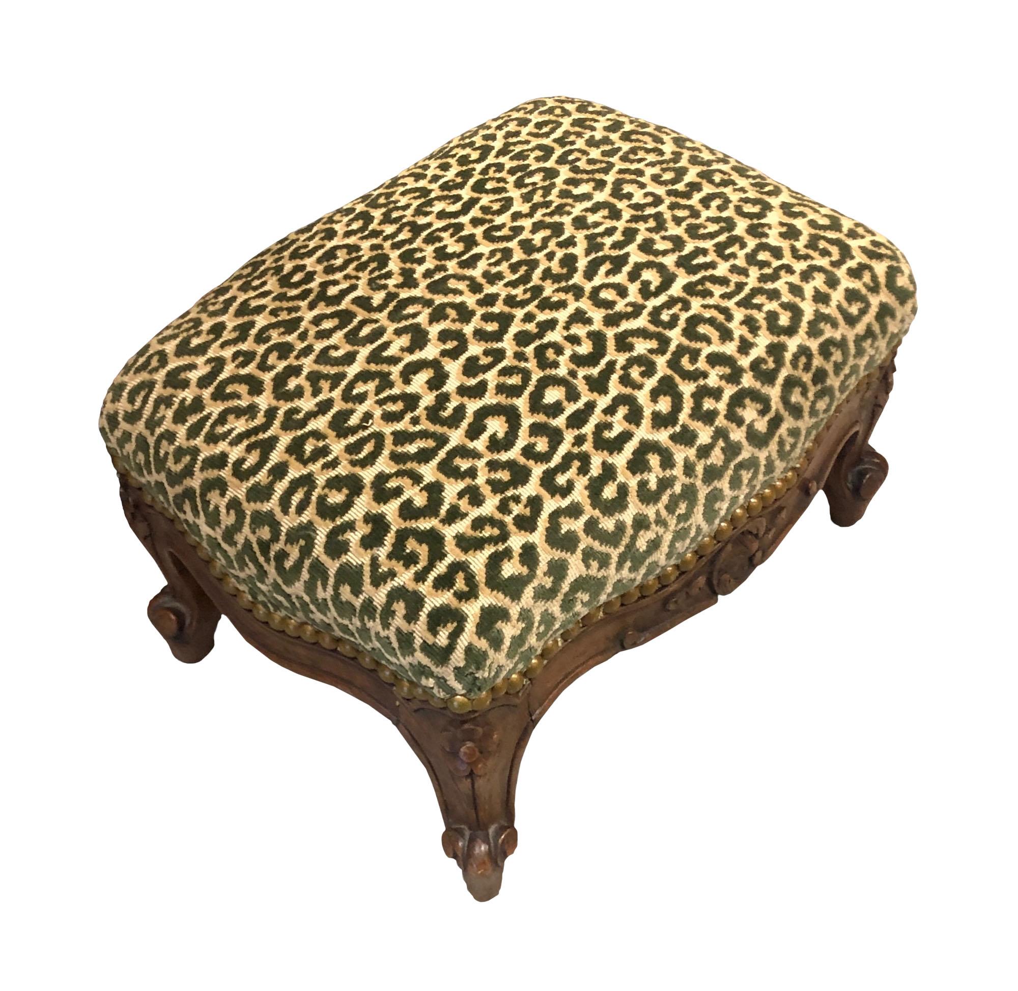 Scalamandre cut velvet animal print fabric in green, rectangular carved wood foot stool. 19th century, France.