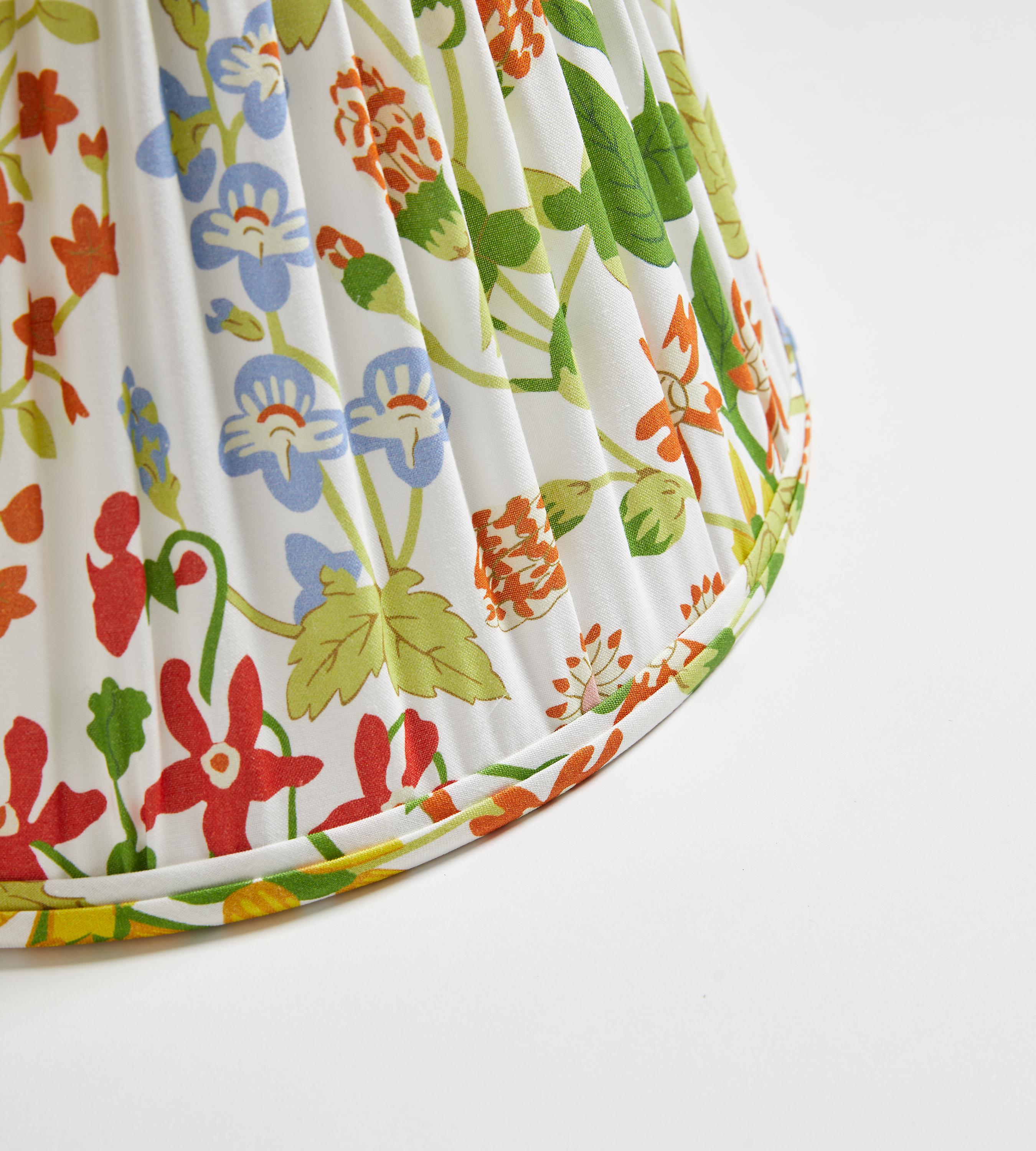 a well-loved pattern from Hinson, is available in printed fabric, wallcovering, luxurious pillows, and now, beautiful, handcrafted lampshades in drum and pleated styles. This energetic, allover pattern features graphic bursts of color.

Hand