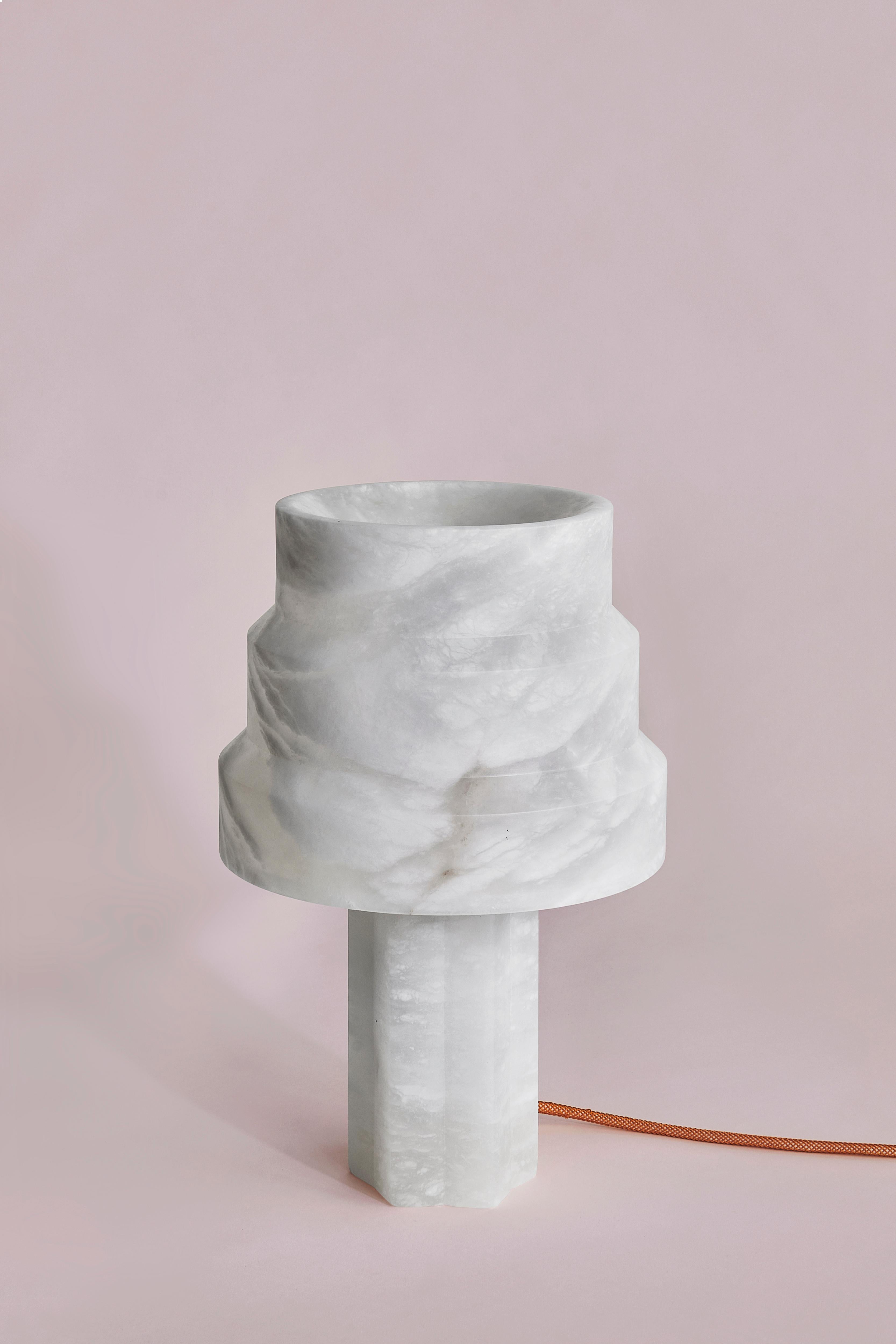 Scale Alabaster Lamp by SB26
Dimensions: W 24 x D 24 x H 36 cm
Materials: Alabaster, LED Source.

In a consistently geometric vocabulary, this family of lamps unveils the
translucent and organic nature of alabaster.
A contrast of shapes and
