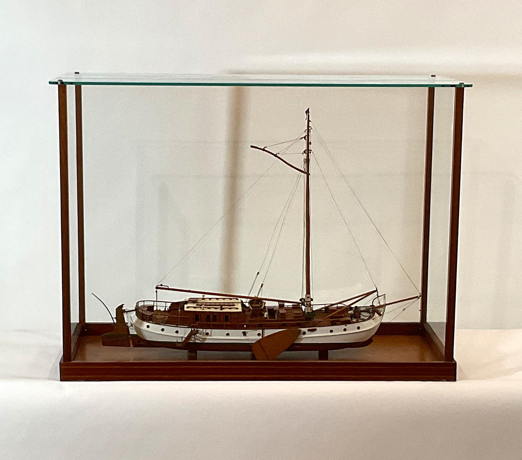 Very fine scale model of a Dutch Lee boarder. With mahogany deck and cabin, launch, spars, grab rails, etc. Details include rope coils, stove pipes, skylights, winch, chain, anchors, chocks, gangway, benches, etc. Expertly rigged custom