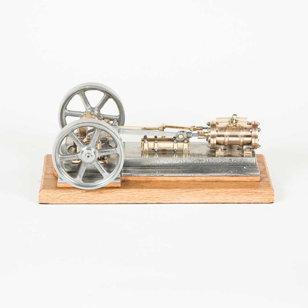 A working scale model of a single cylinder twin spoked flywheel horizontal stationary open crank mill steam engine, circa 1880. 

Mounted on a later oak base.