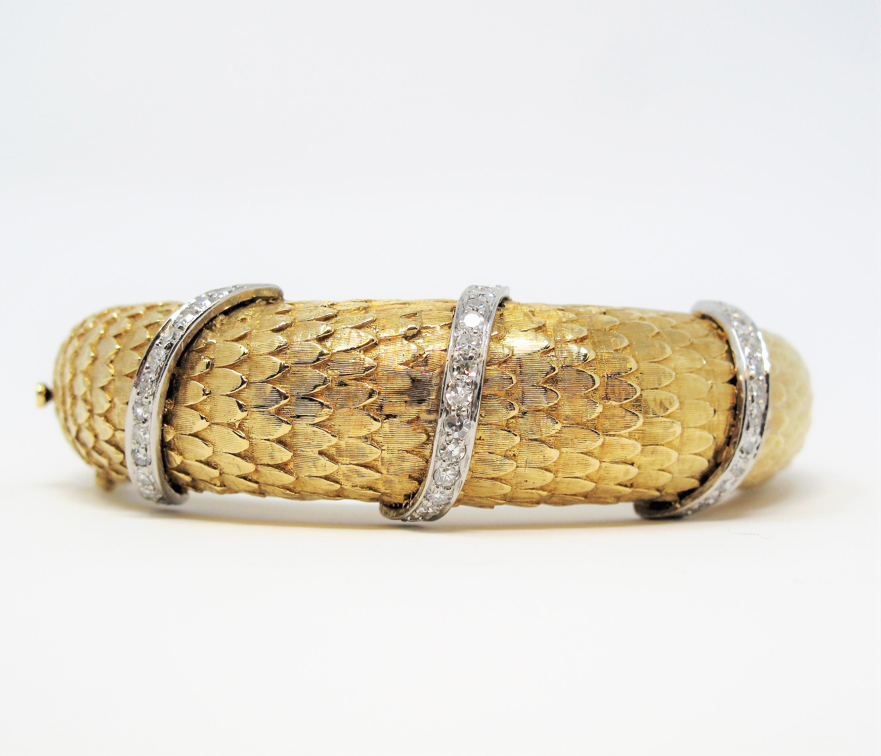 Incredible textured 18 karat gold bangle bracelet with pave diamond accents. This stunning piece has a delightfully detailed texture that you can practically feel without even touching it! The contrasting diamond embellishments add a subtle movement