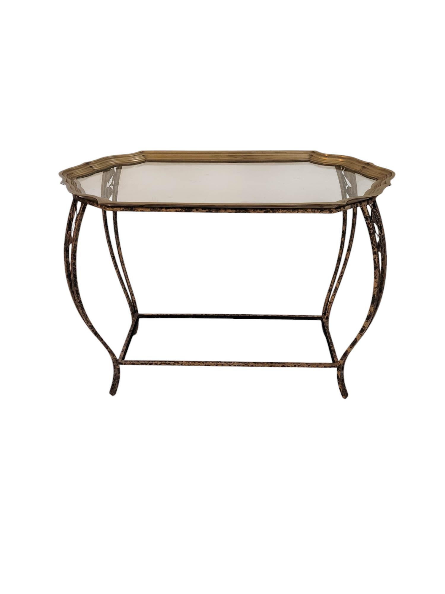 Cette table d'appoint allie des éléments organiques et raffinés. Sa base en fer forgé, finie avec une technique d'antiquation noire et dorée, met en valeur de délicates découpes en forme de feuilles, insufflant à la pièce une inspiration naturelle.