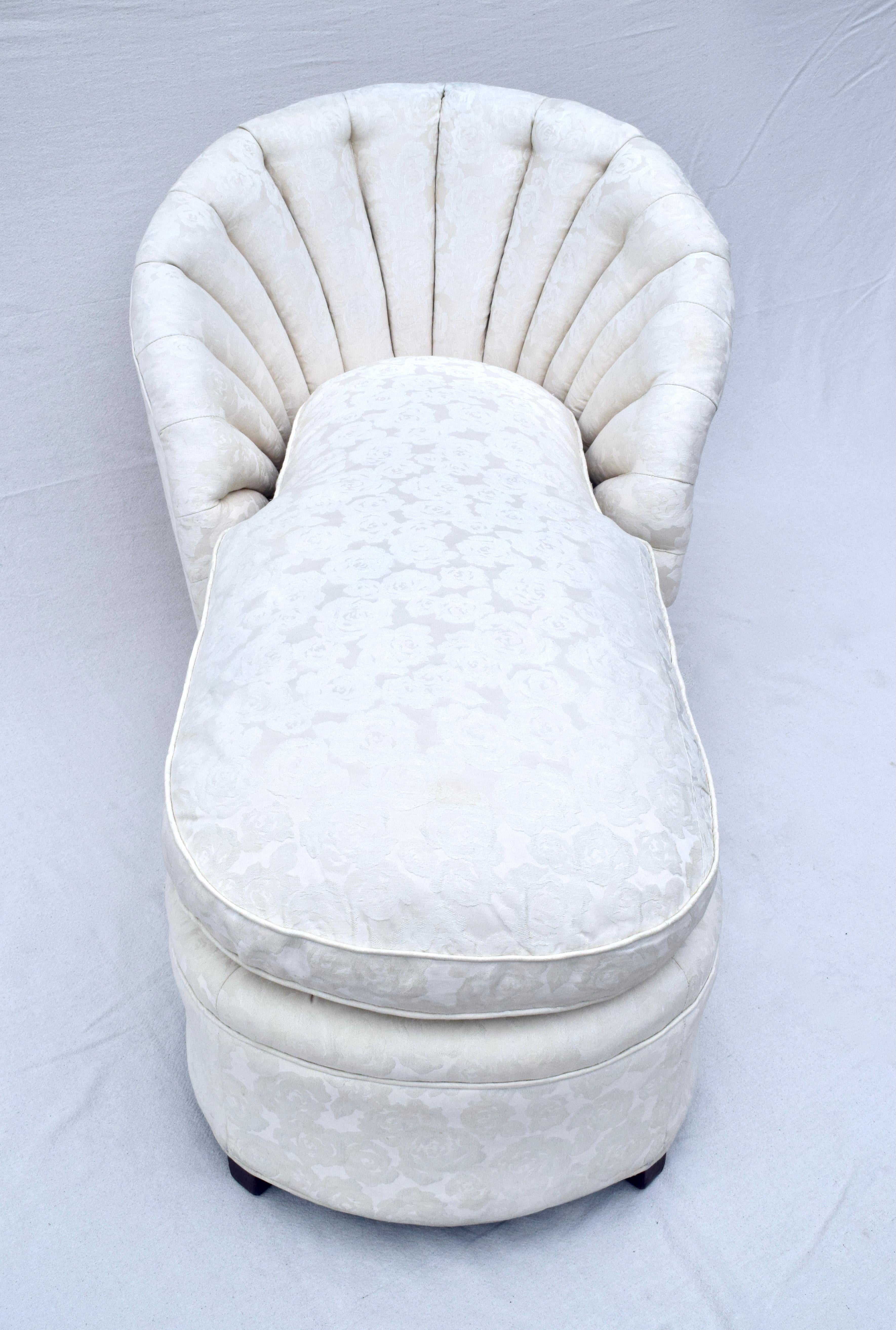 A custom sculpted & scalloped channel back clamshell form chaise lounge of exceptional high quality with single plush goose down feather cushion. Original floral Damask upholstery is in beautifully maintained condition showing very minor signs of