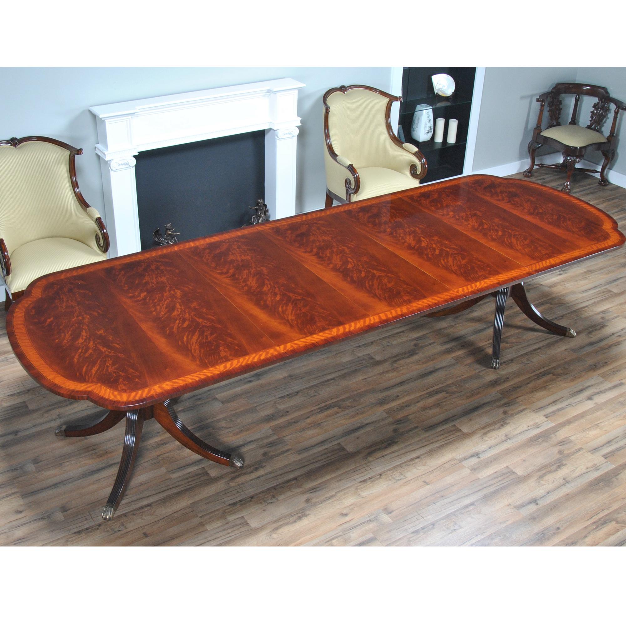 This Scalloped Corner Mahogany Dining Table has a lot of great features that combine to make it a favorite. Shown here with a veneered rosewood edge this table now ships with a reeded solid mahogany edge. A photo of the current edge type can be seen