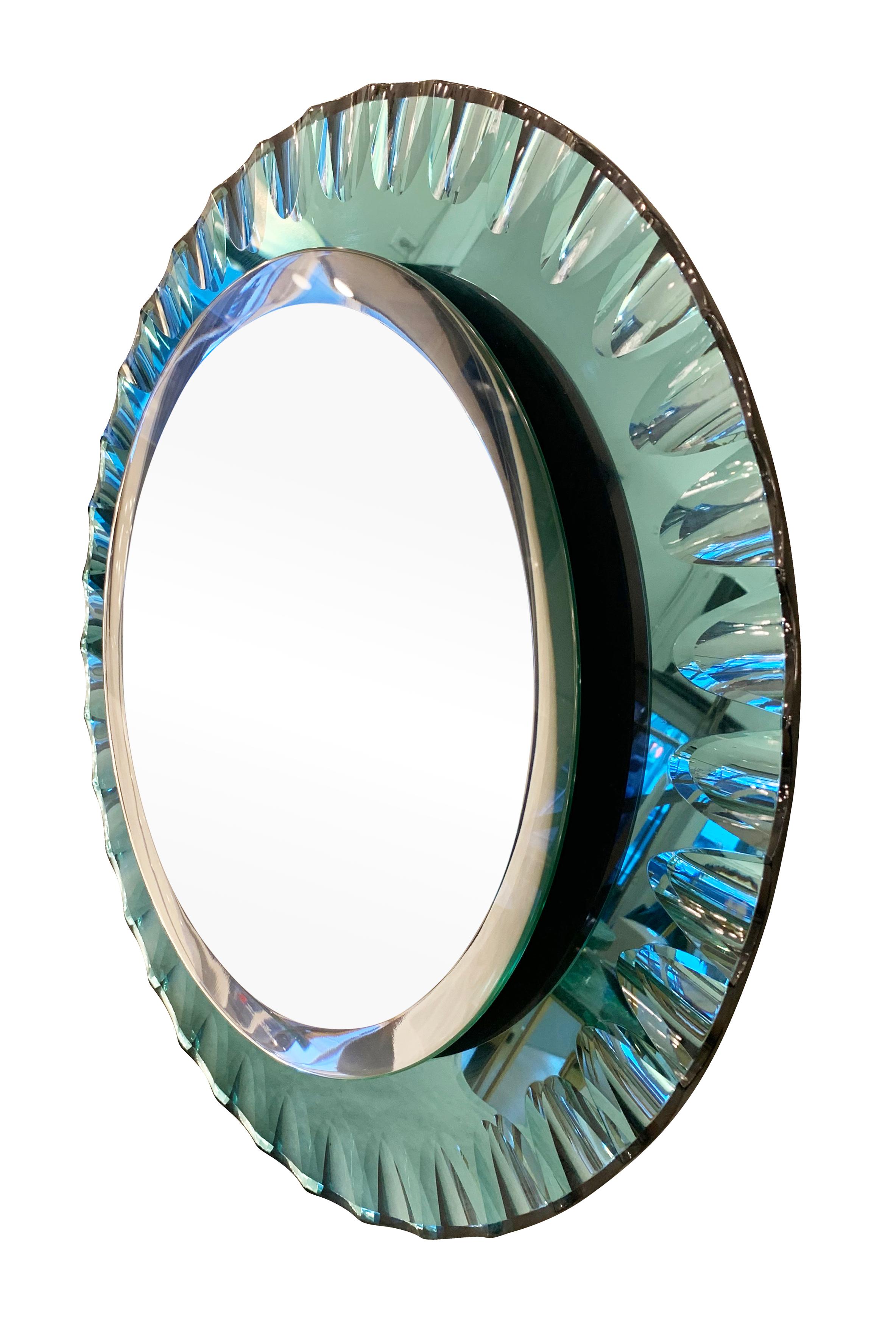Italian midcentury mirror by Cristal Arte with a scalloped turquoise glass edge and a beveled canter.

Condition: Excellent vintage condition, minor wear and age spots consistent with age and use.

Diameter: 27.5”.


