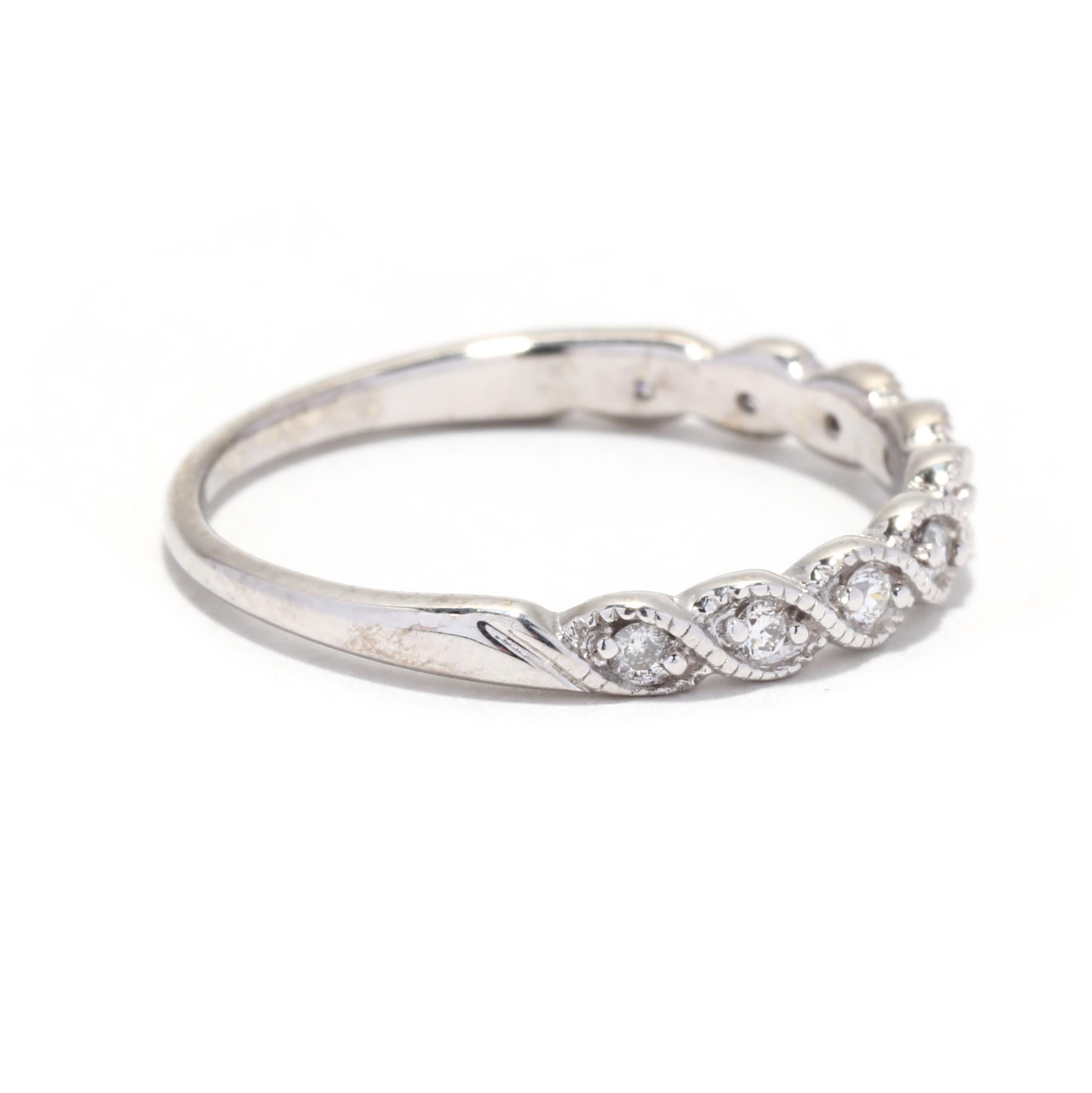 A vintage 14 karat white gold scalloped diamond wedding band ring. This stackable band features  a scalloped design of marquise shapes set with round brilliant cut diamonds weighing approximately .15 total carats and with a tapered band.

Stones:
-