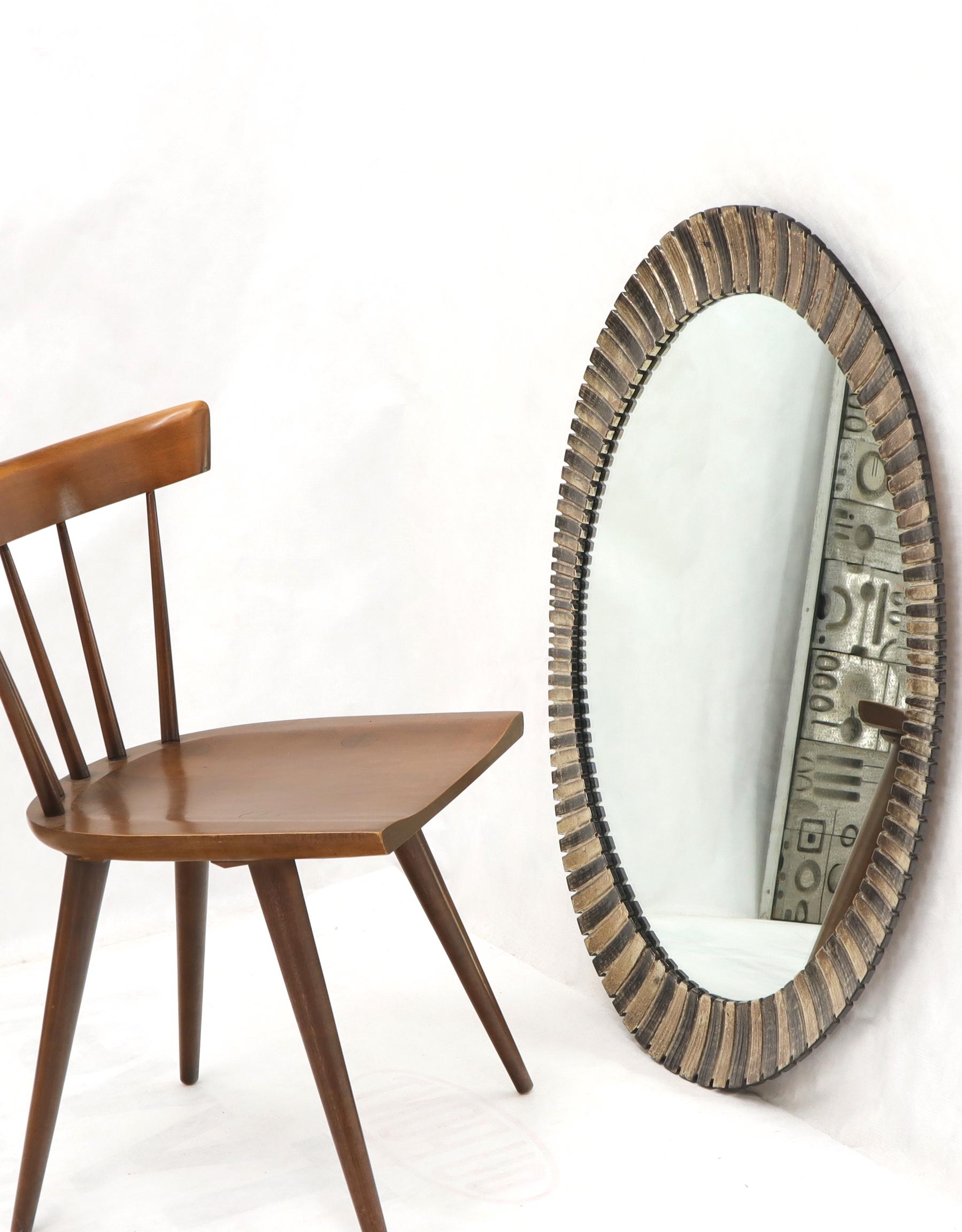 Scalloped edge Mid-Century Modern oval mirror.