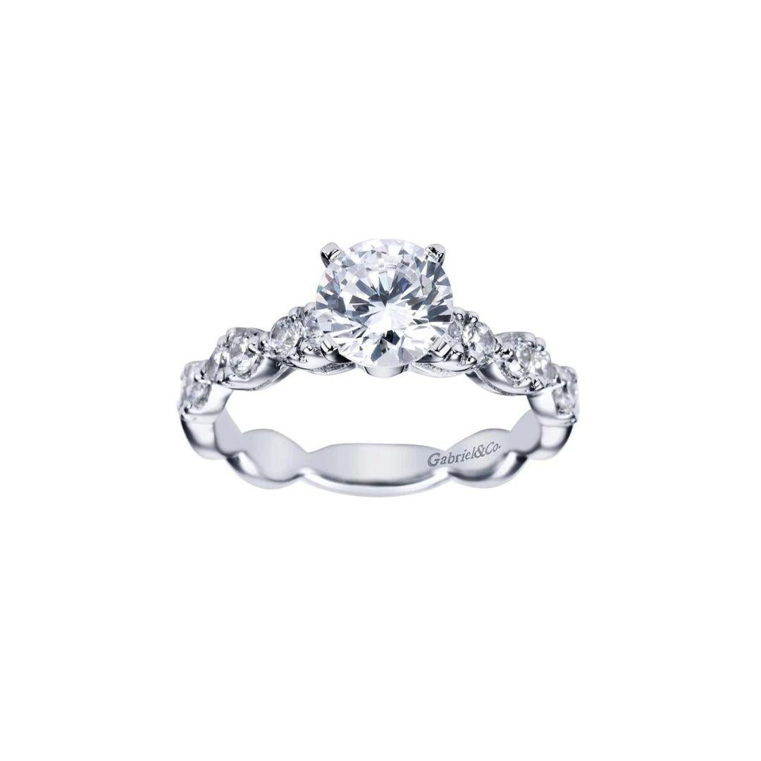 Ladies' 14k White Gold Diamond Engagement Ring by Gabriel Co. Romantic scalloped design combined with bead set natural white diamonds create a timeless, classic look. Center diamond is 0.50 ct weight, F-G color, VS2 clarity. Side diamonds 0.50 ctw,