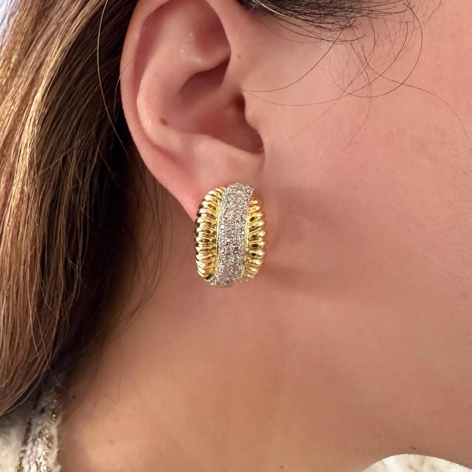Scalloped Gold and Diamond Pave Half Hoop Earrings in 18k Yellow Gold

The Diamond Earrings feature 4 Rows of Pave Diamonds in the center of each earring with Yellow Gold Scalloped edges on either side, all set in 18k Yellow Gold. The earrings are