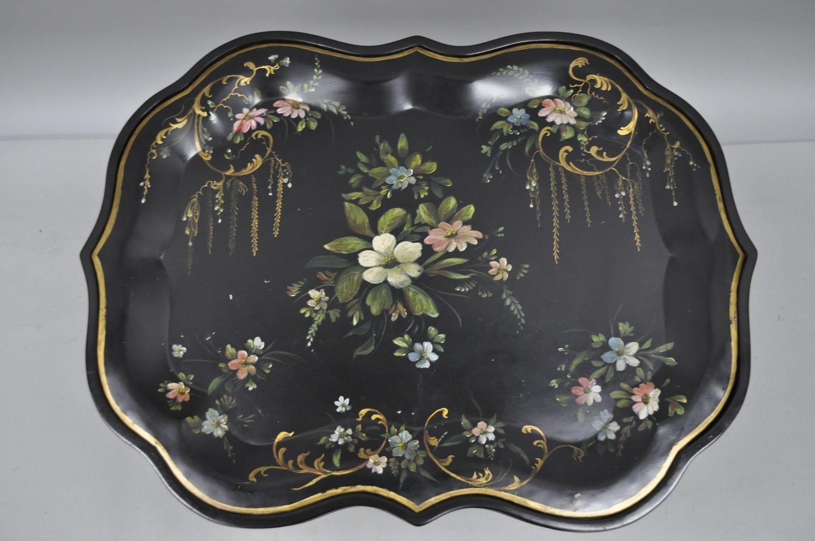 Beautiful hand-painted tole metal serving tray table. Item features removable tole metal scalloped tray, hand-painted details, wooden faux bamboo base, and elegant style and form, circa mid- late 20th century. Measurements: 22