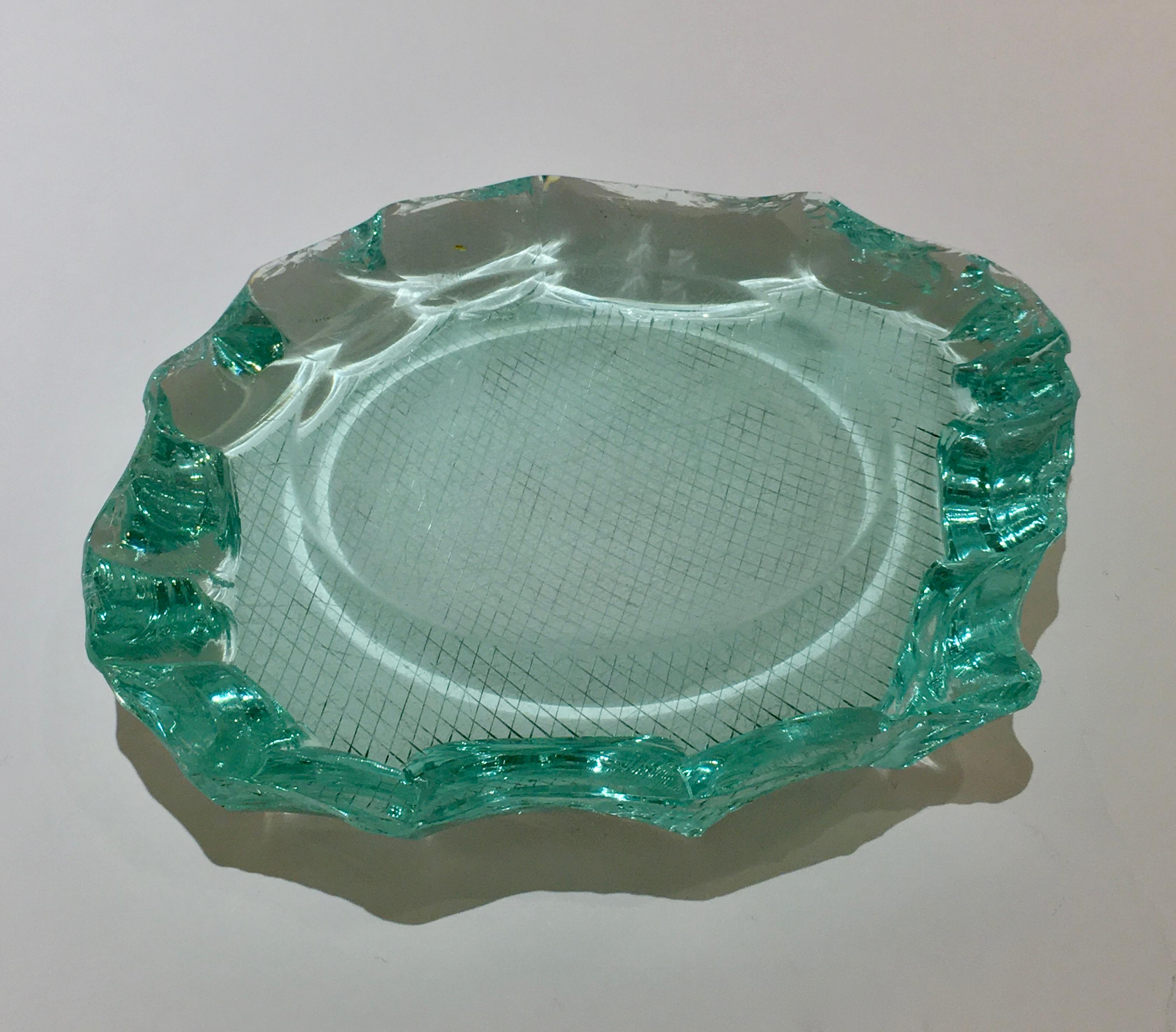 A circa 1930 ‘scalpellato’ handcut glass dish designed by Pietro Chiesa for Fontana Arte. The beautiful aquamarine coloured glass was produced using the ‘scalpellato’ or ‘chiselled’ technique and has a circular concave cut-out at its centre. The