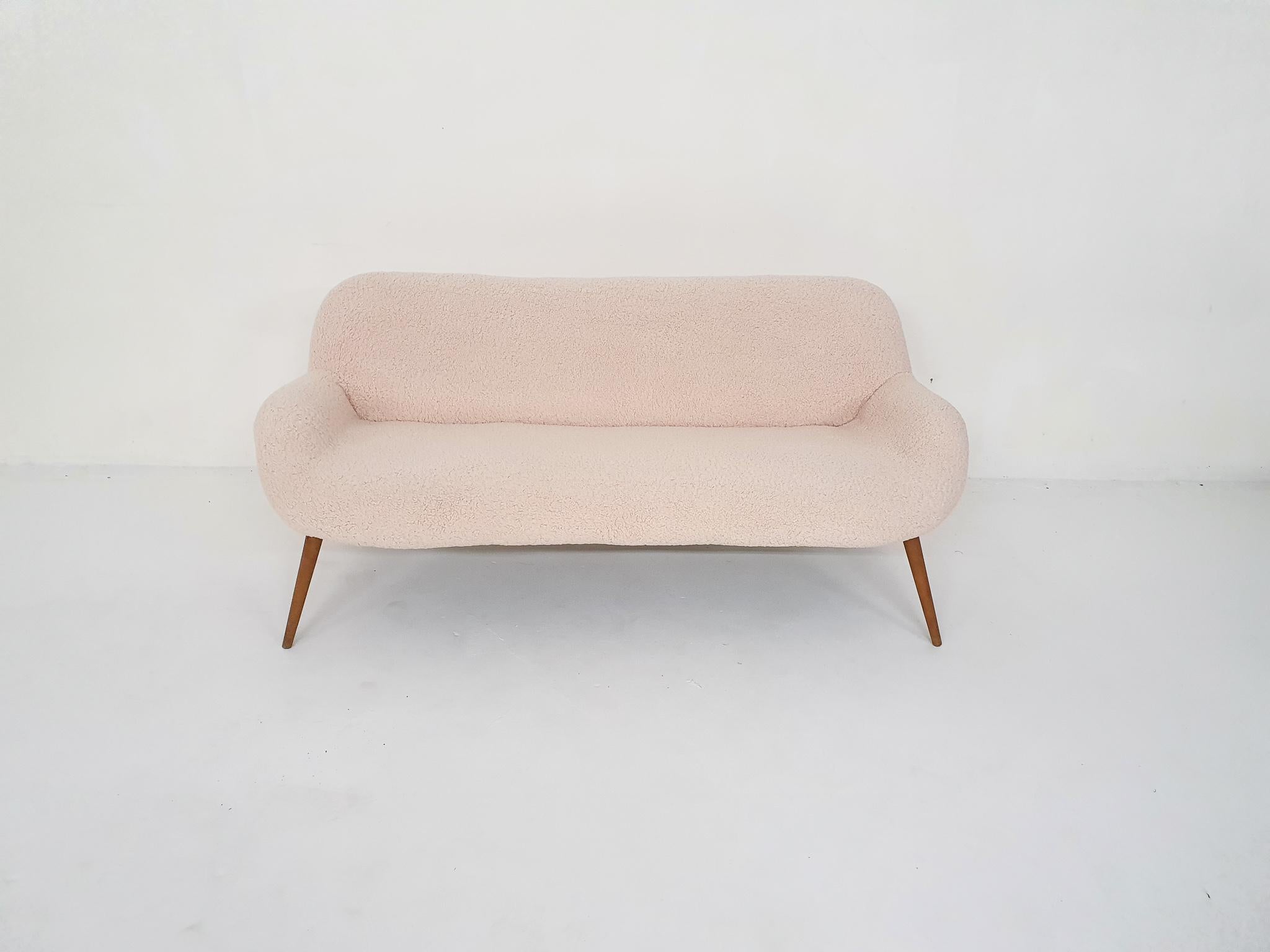 Scandinavian Modern sofa, re-upholstered in beige boucle fabric and teak legs. In the style of Nanna Ditzel.