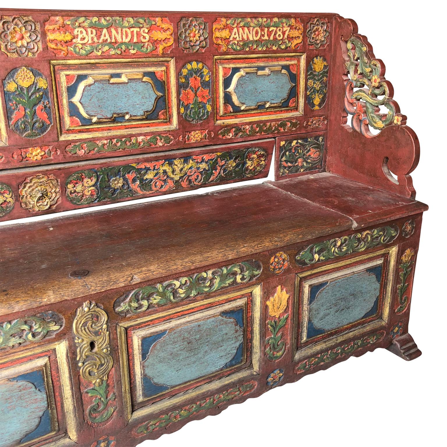 Scandinavian 18th century carved and painted Folk bench, Anno, 1787.
The Folk Art bench is probably Danish and made in connection the engagement or marriage ceremony. Carved into the bench is the name of the wife to be; 